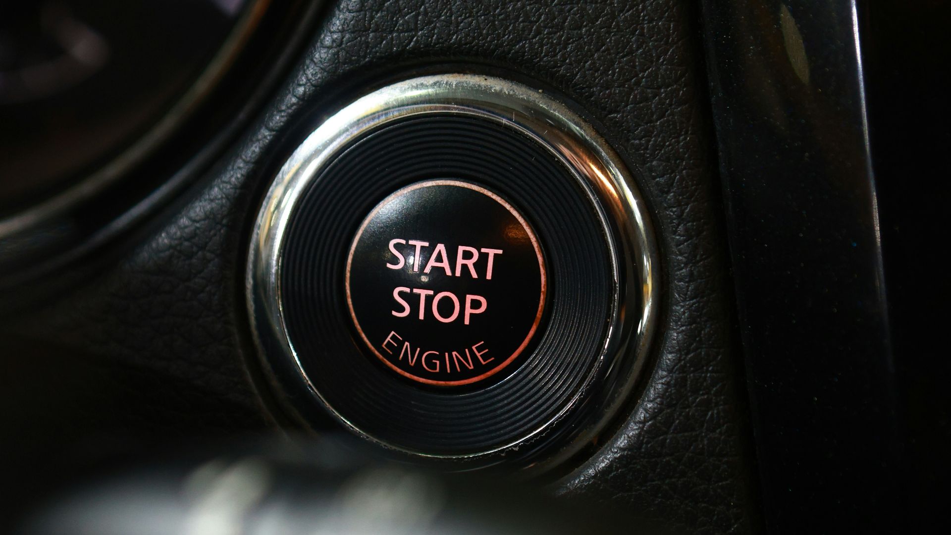 the start button of a car with a speedometer