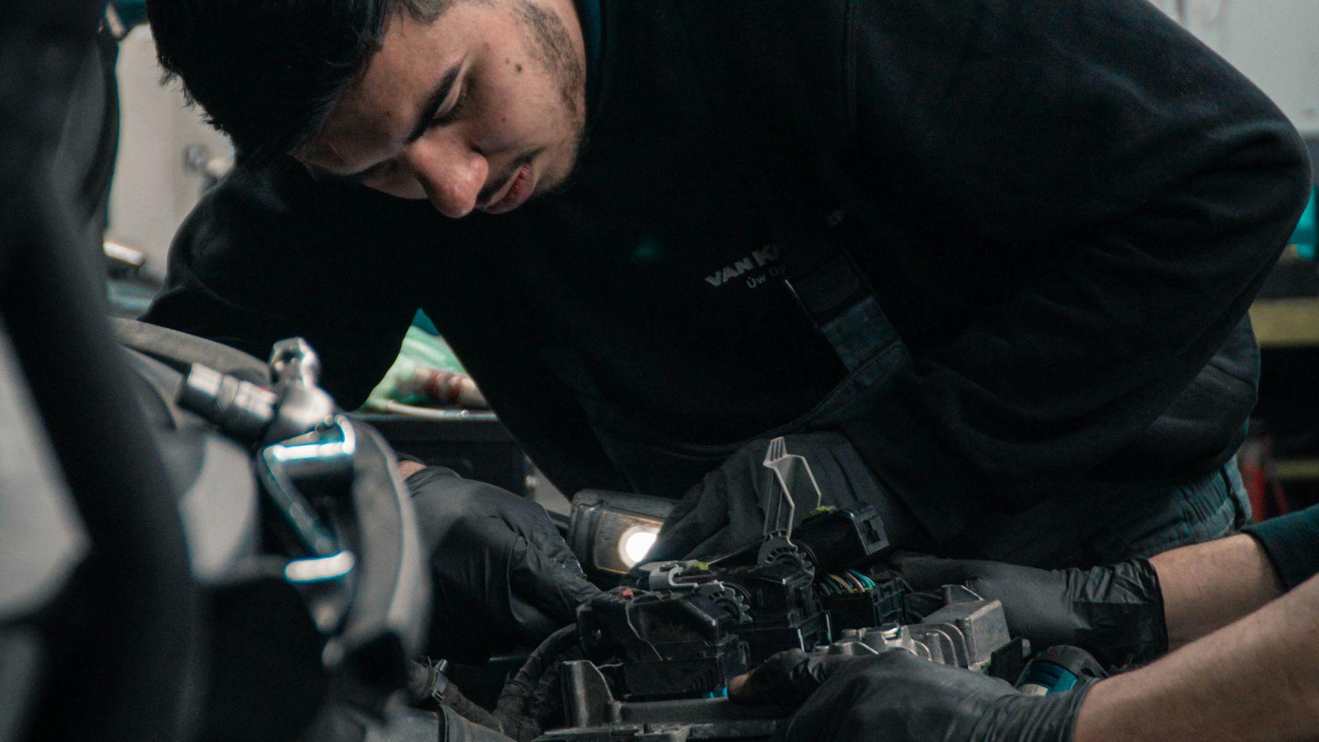 man in black jacket and blue denim jeans riding motorcycle