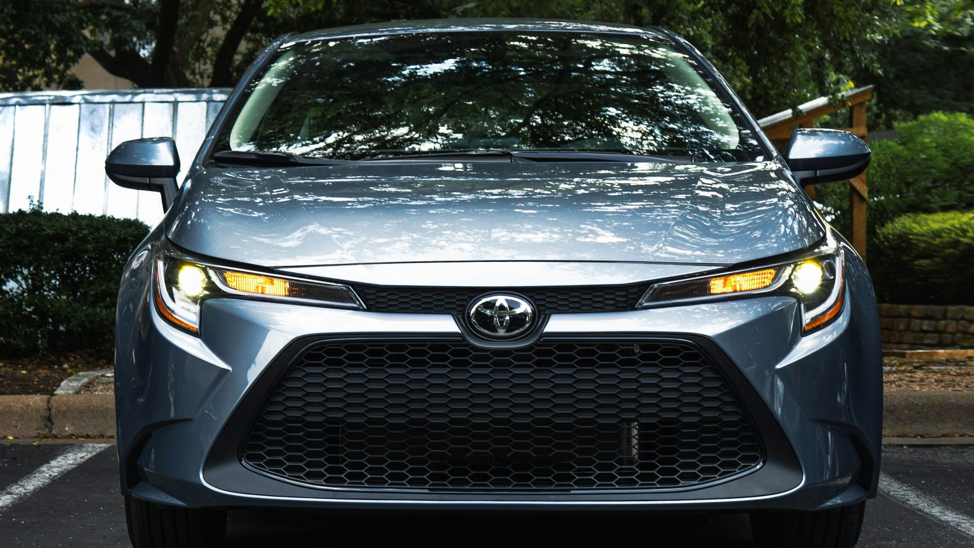 black mercedes benz car parked near green trees during daytime
