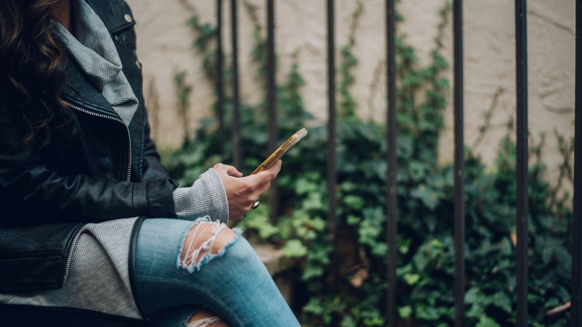 woman using gold smartphone