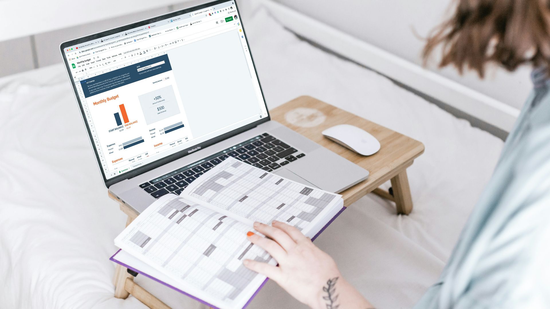 a person sitting on a bed with a laptop