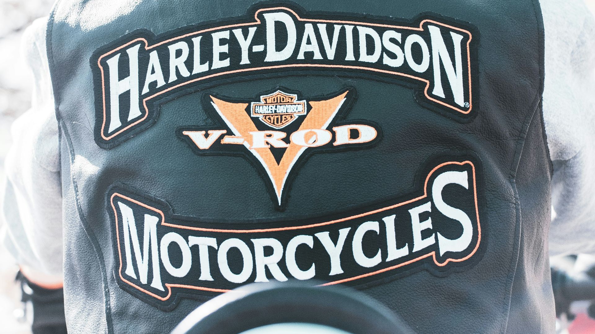 the back of a man wearing a harley davidson motorcycle jacket
