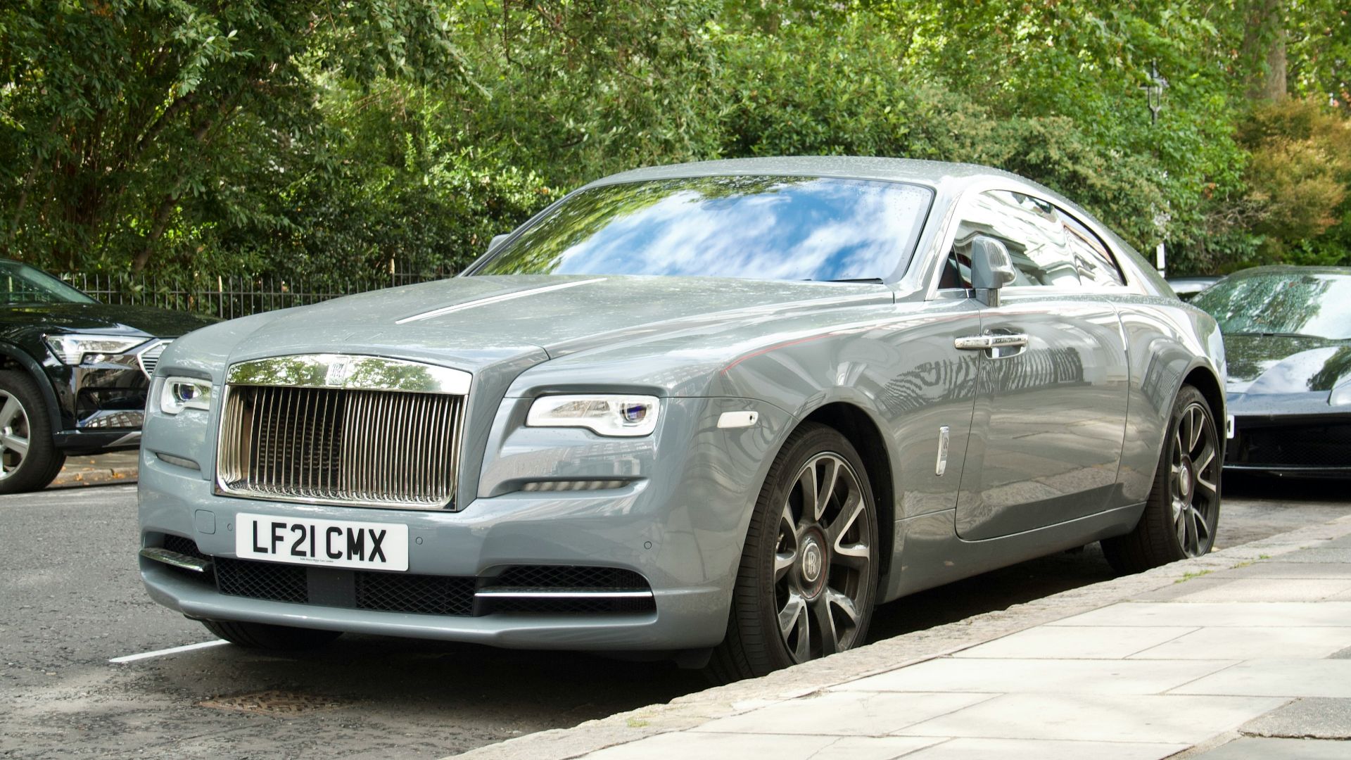 a silver car parked on the side of a road