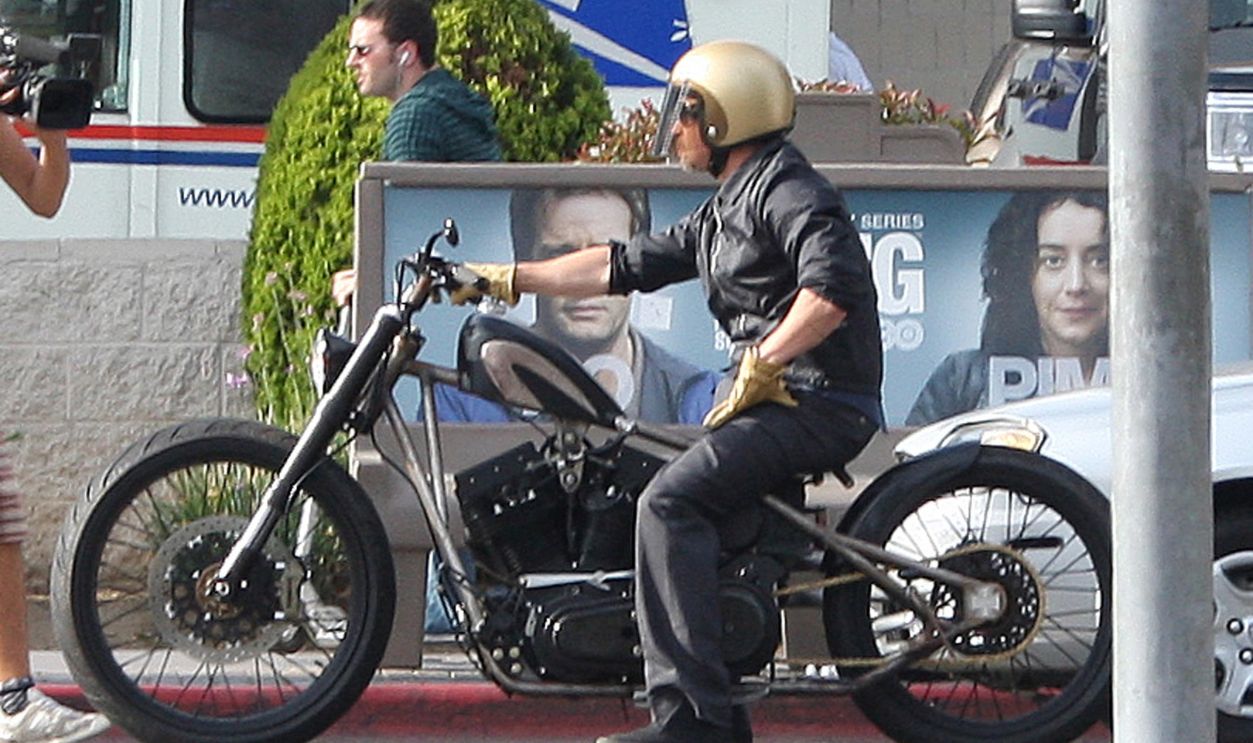 Brad Pitt ride his customized motorcycle in Los Feliz with a nice gesture for the photographer