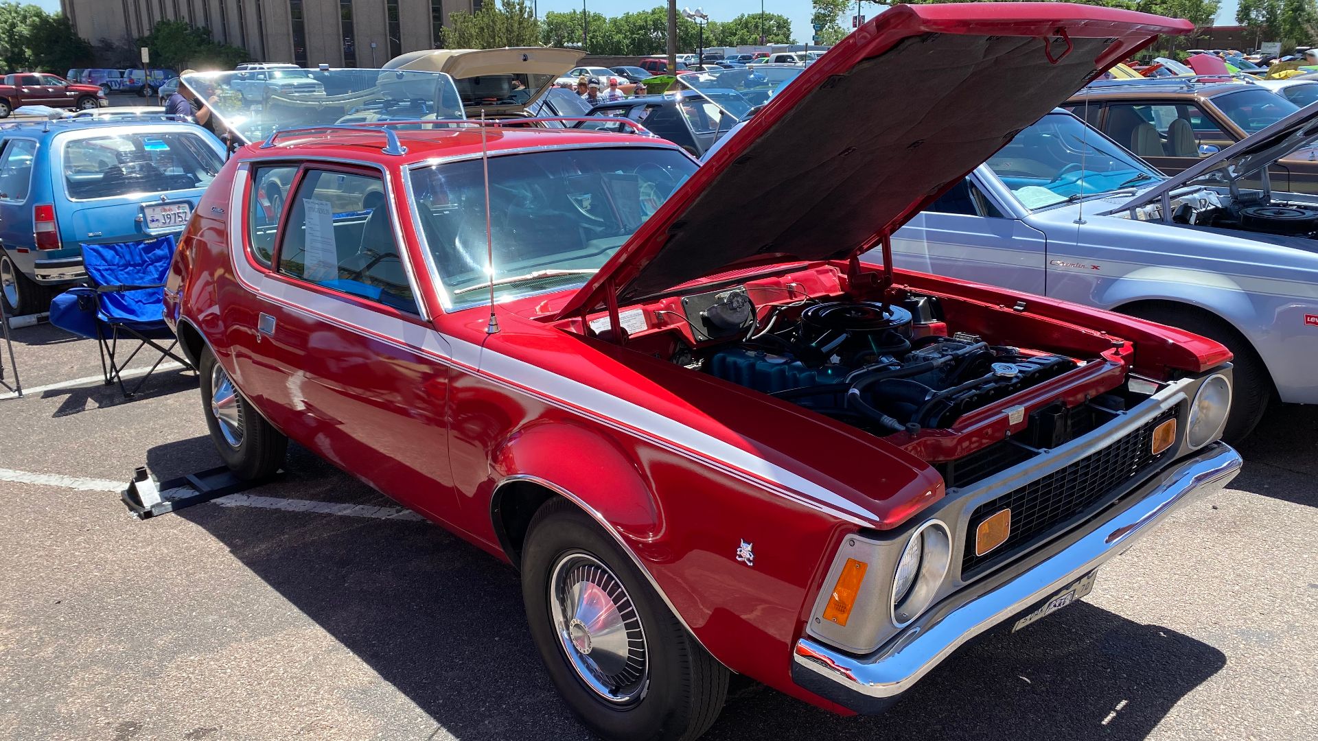File:1970 AMC Gremlin all original finished in red with white stripe 232 auto AC at 2021 AMO meet 02of15.jpg