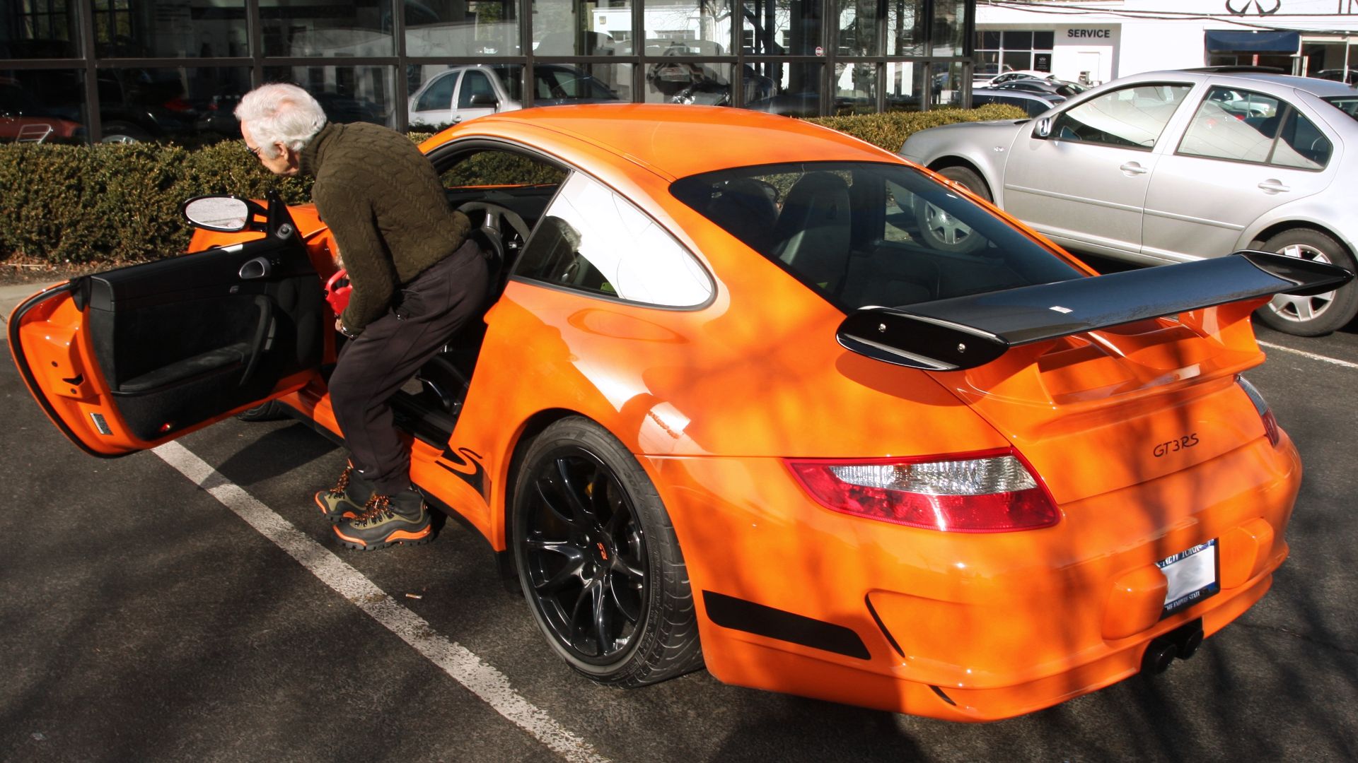 File:Ralph Lauren getting in his orange 997 GT3 RS.jpg
