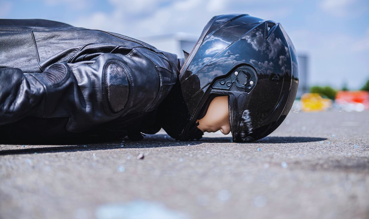 Gettyimages - 1158651337, Insurer accident researcher on the death risk of motorcyclists 30 July 2019, North Rhine-Westphalia, Münster: A motorcyclist as a crash test dummy lies on the road after a crash test of the accident researchers. 