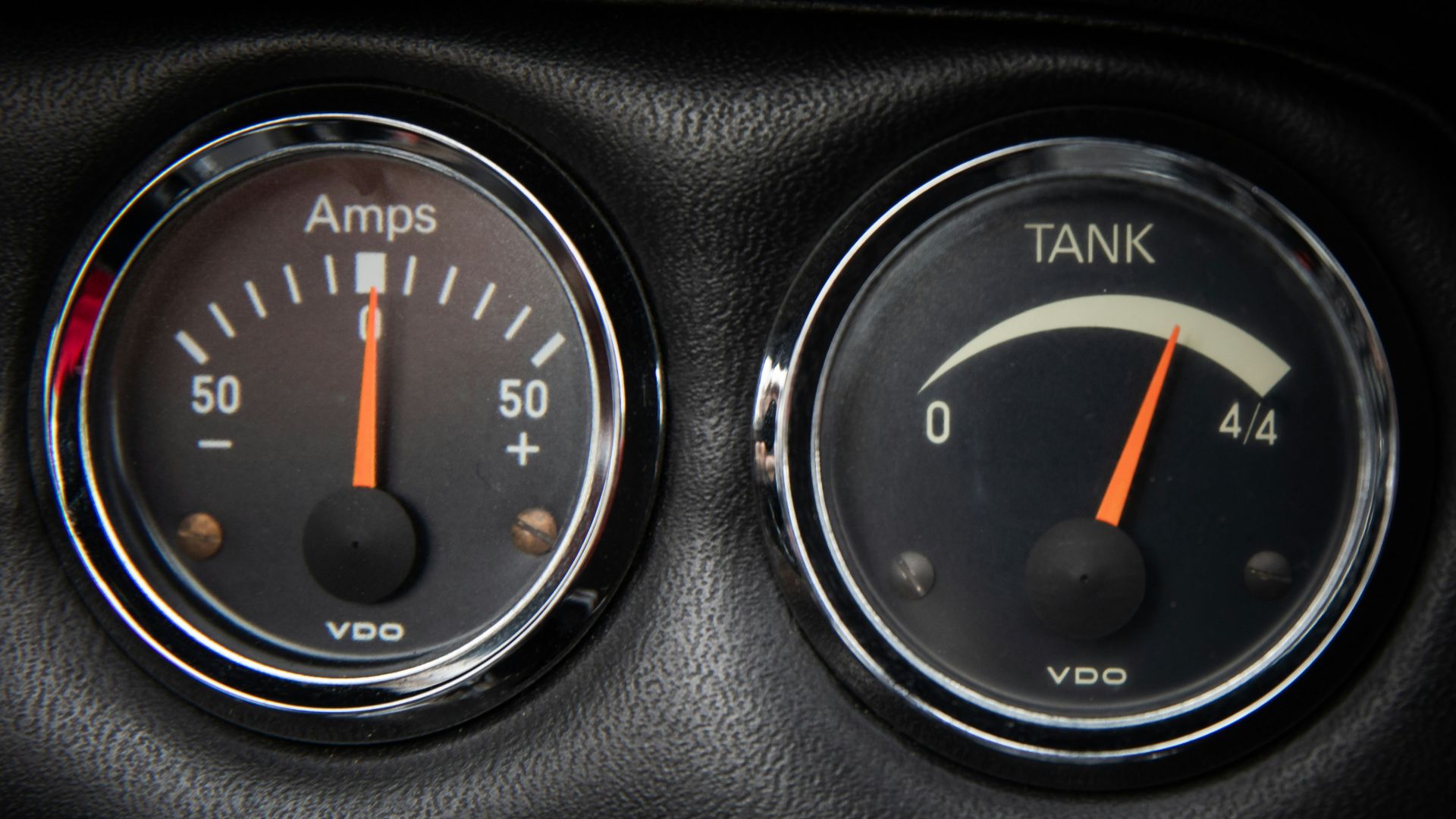 a close up of two gauges in a car