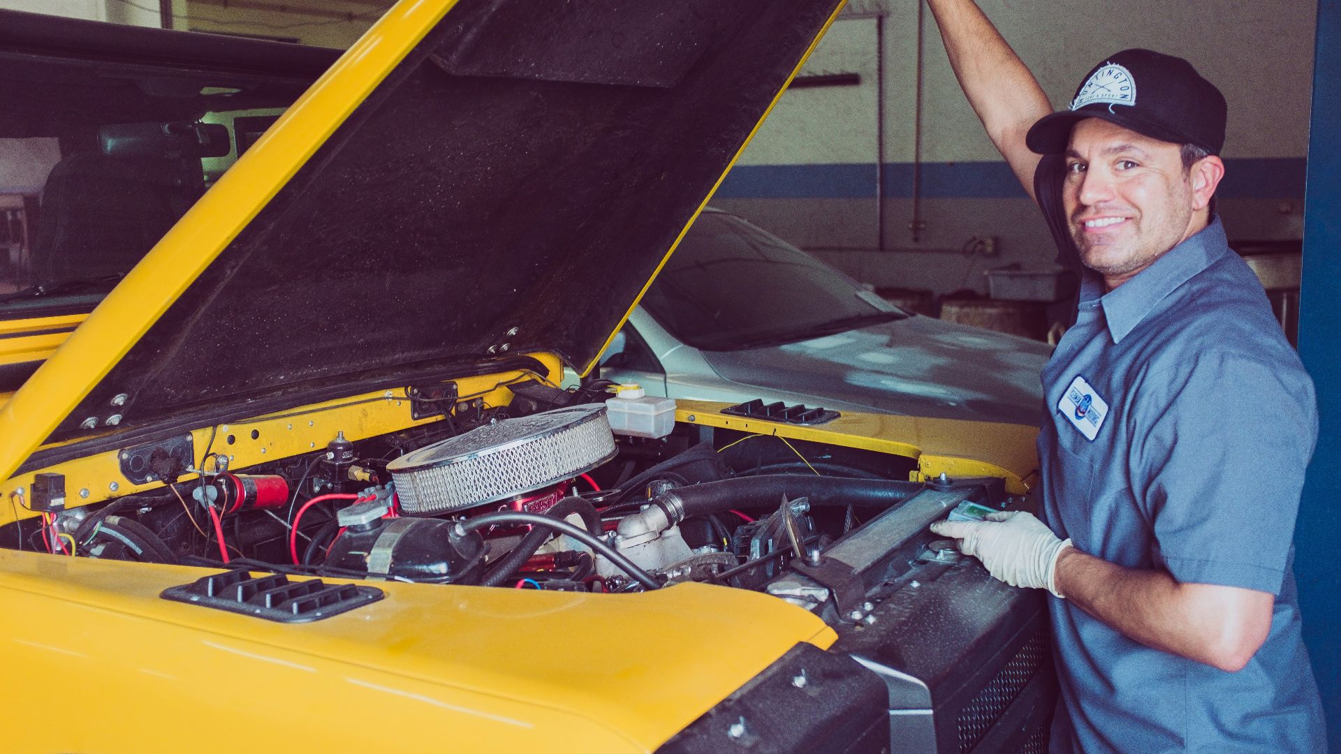 man holding open-wide car trunk