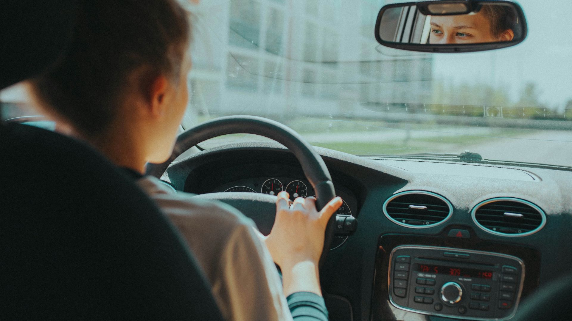 man in black shirt driving car