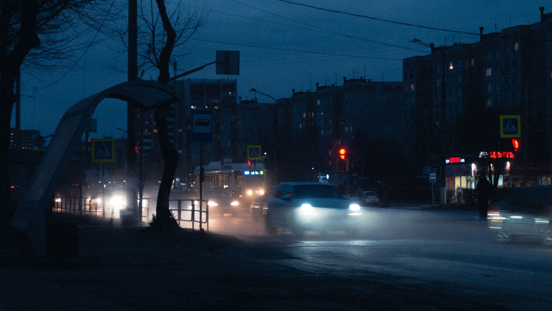 a car driving down a street at night