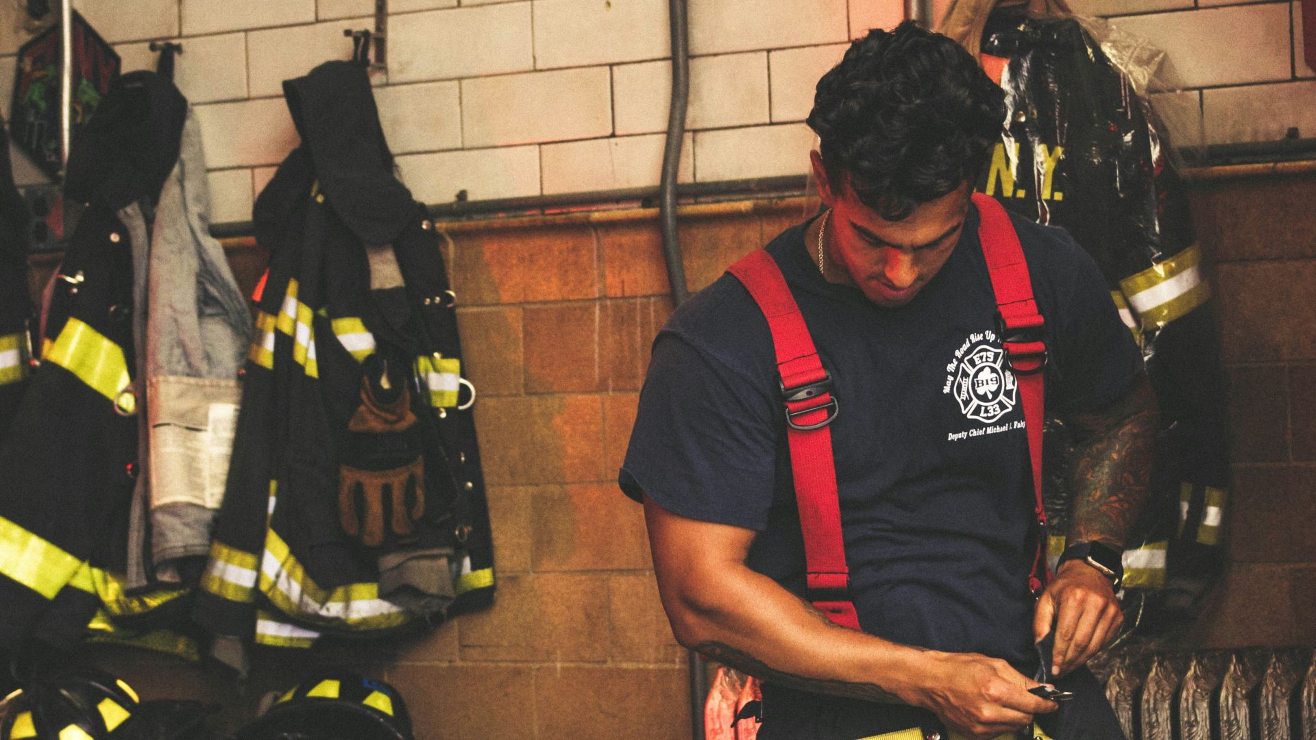 man wearing harness near black jackets