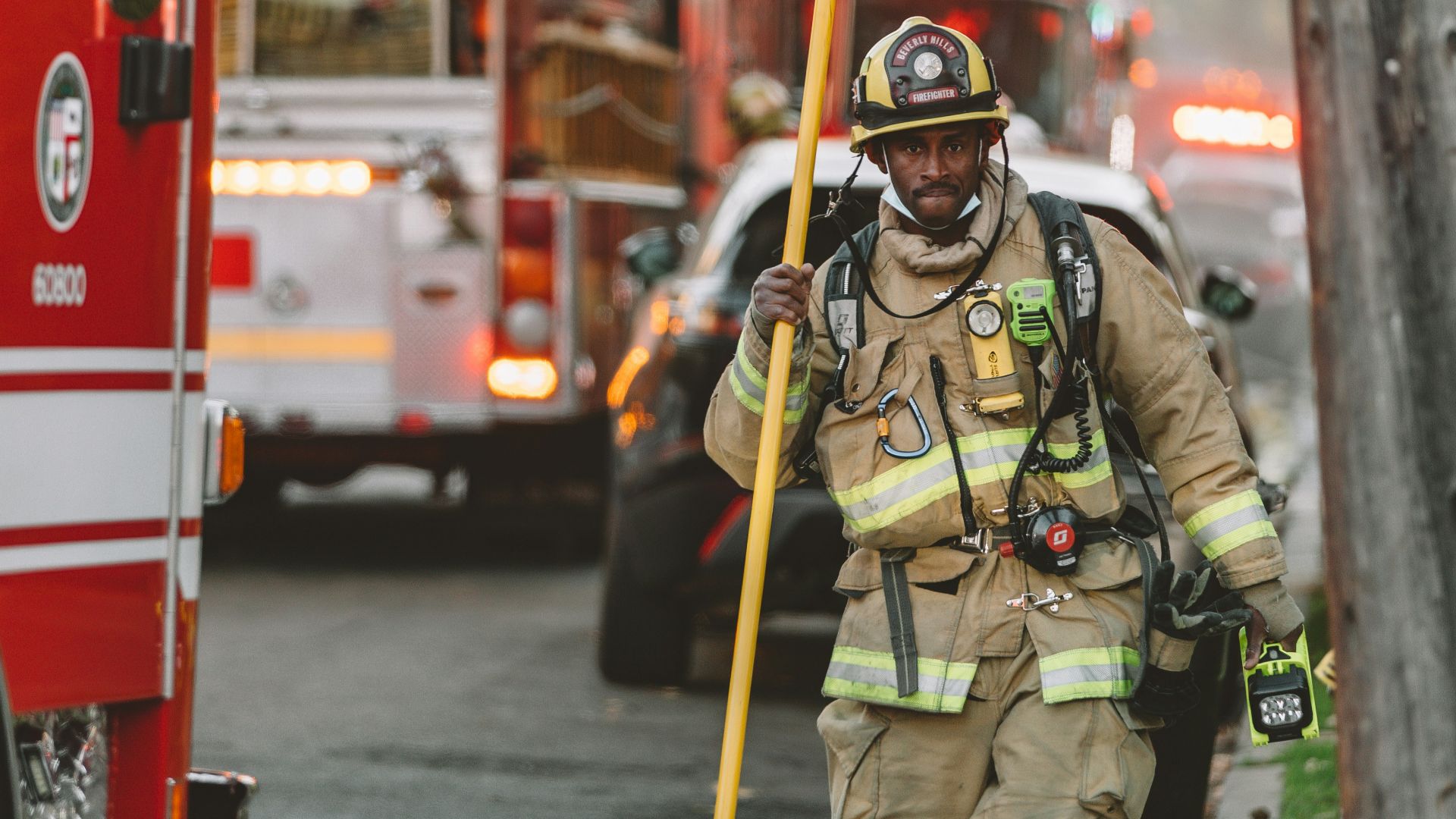 man in green and brown camouflage uniform standing near red bus during daytime