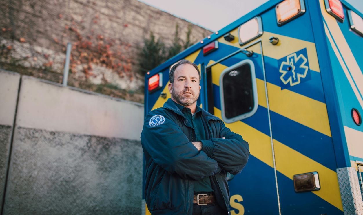 EMT Standing Behind an Ambulance