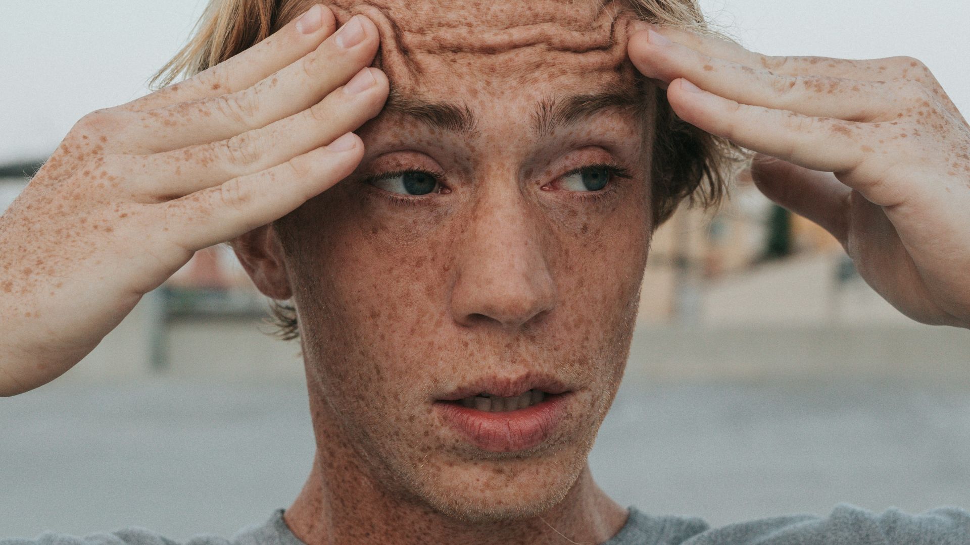 man in gray crew neck shirt with brown hair