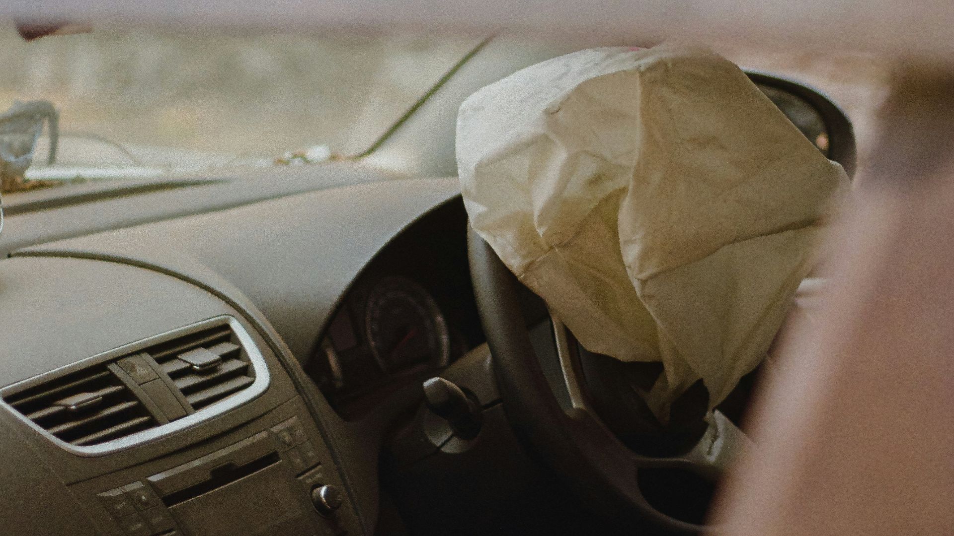 a car with a paper bag in the passenger seat