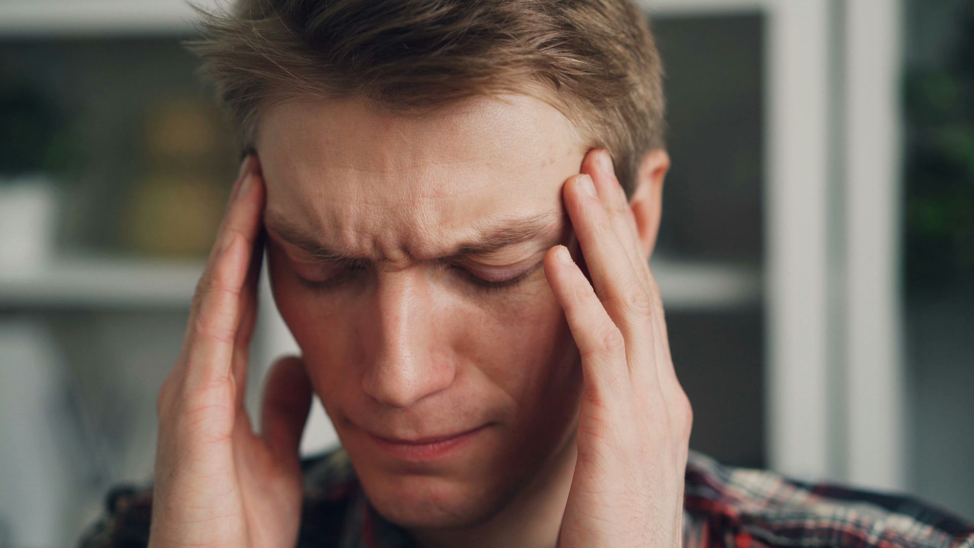 a man holding his hands to his ears