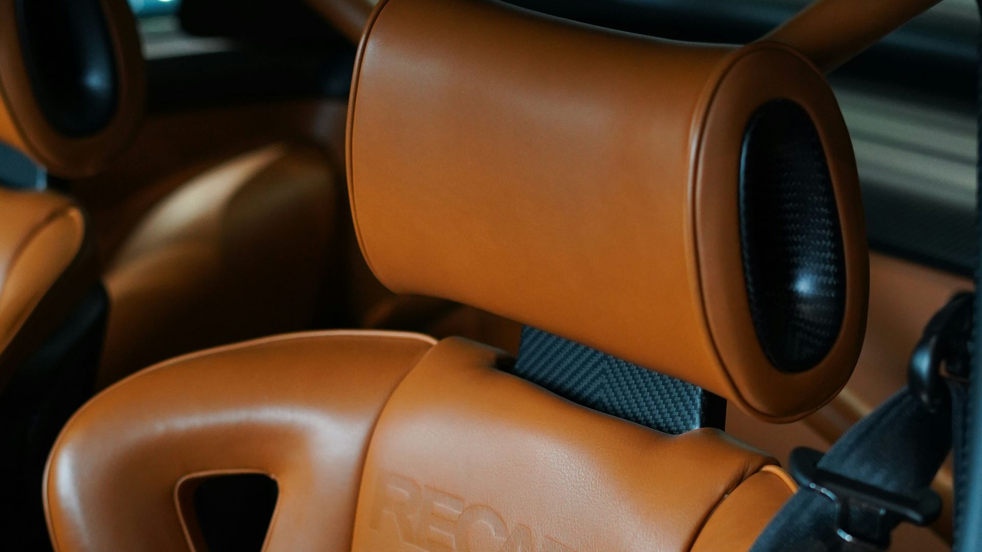 Brown leather recaro car seats with headrests.