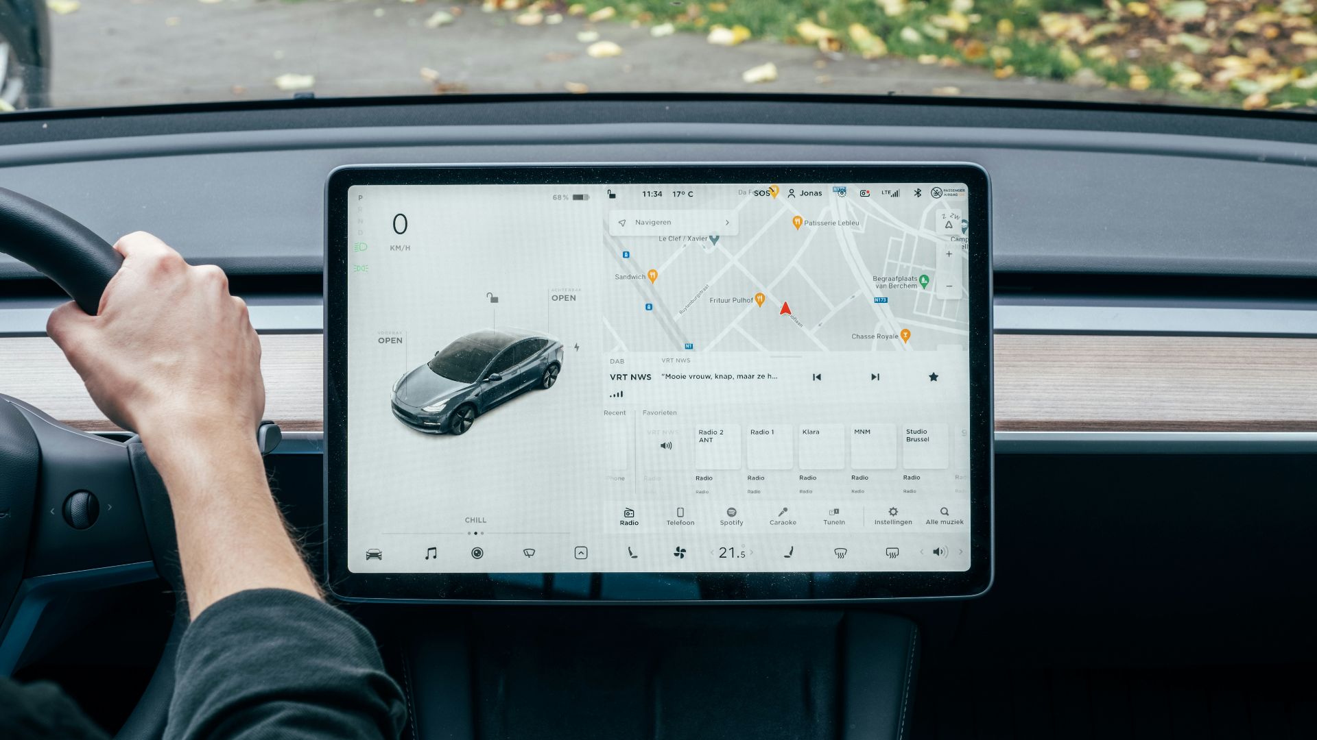 a person driving a car with a computer on the dashboard