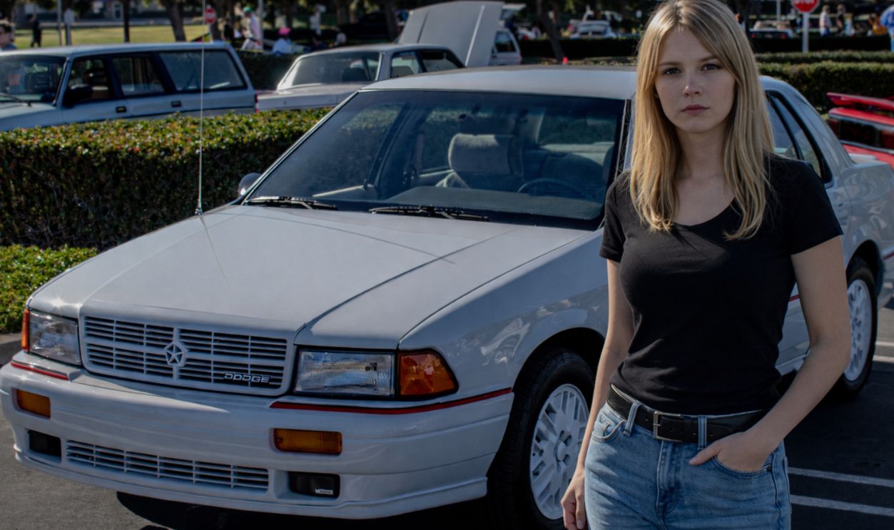 women standing before a car