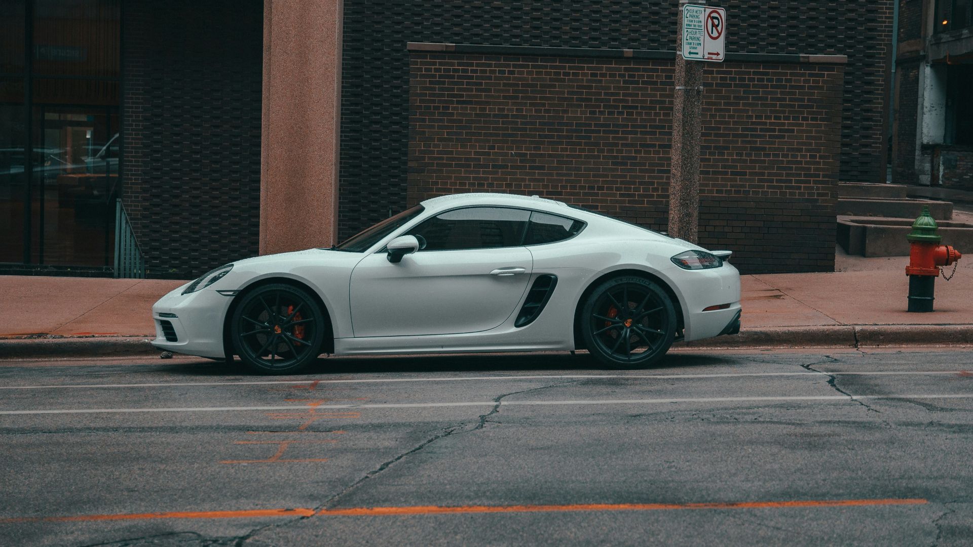 a white sports car parked on the side of a street