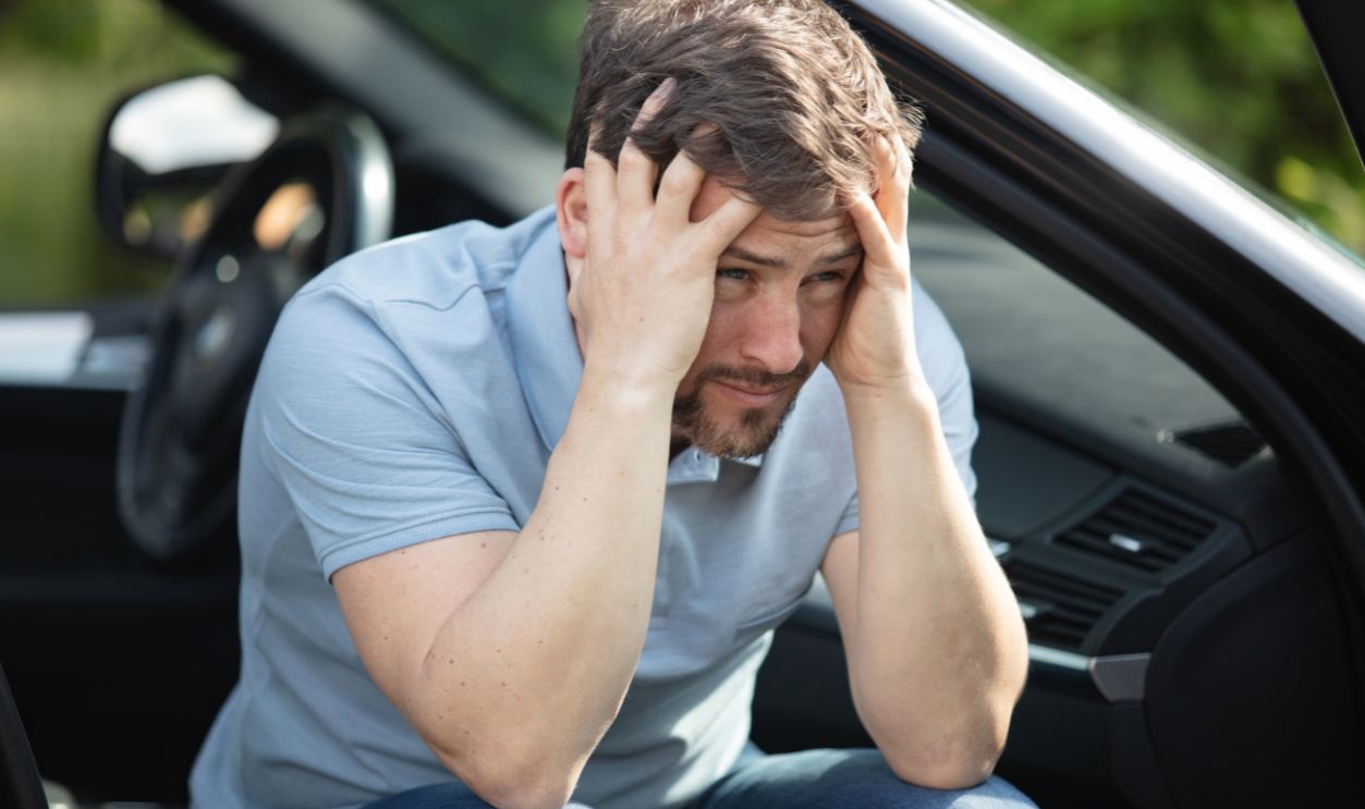 a depressed man is sad in a car
