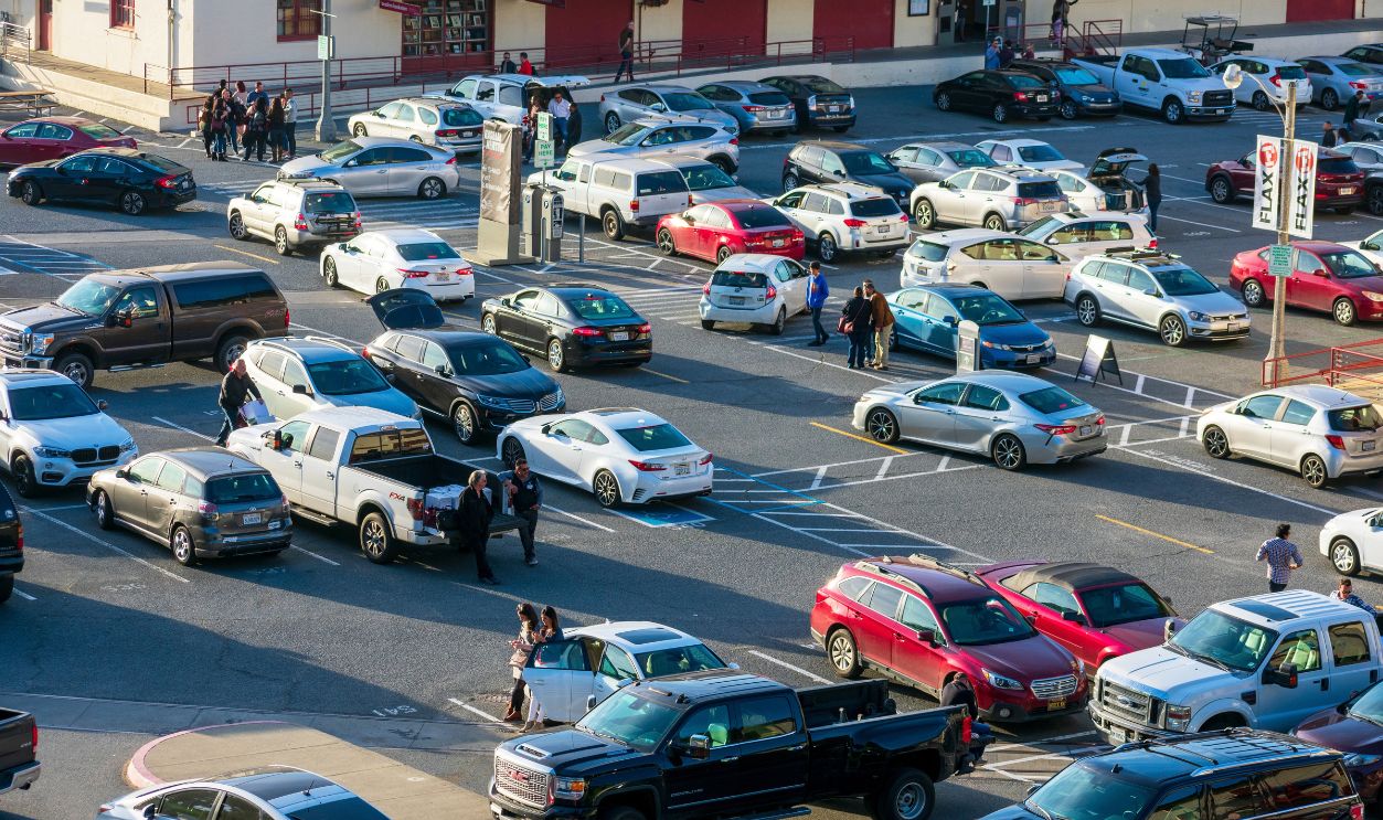 Aerial view of busy and full parking lot with cars arriving and leaving, people waiting at Fort Mason Center for Arts and Culture - San Francisco, California, USA - 2020