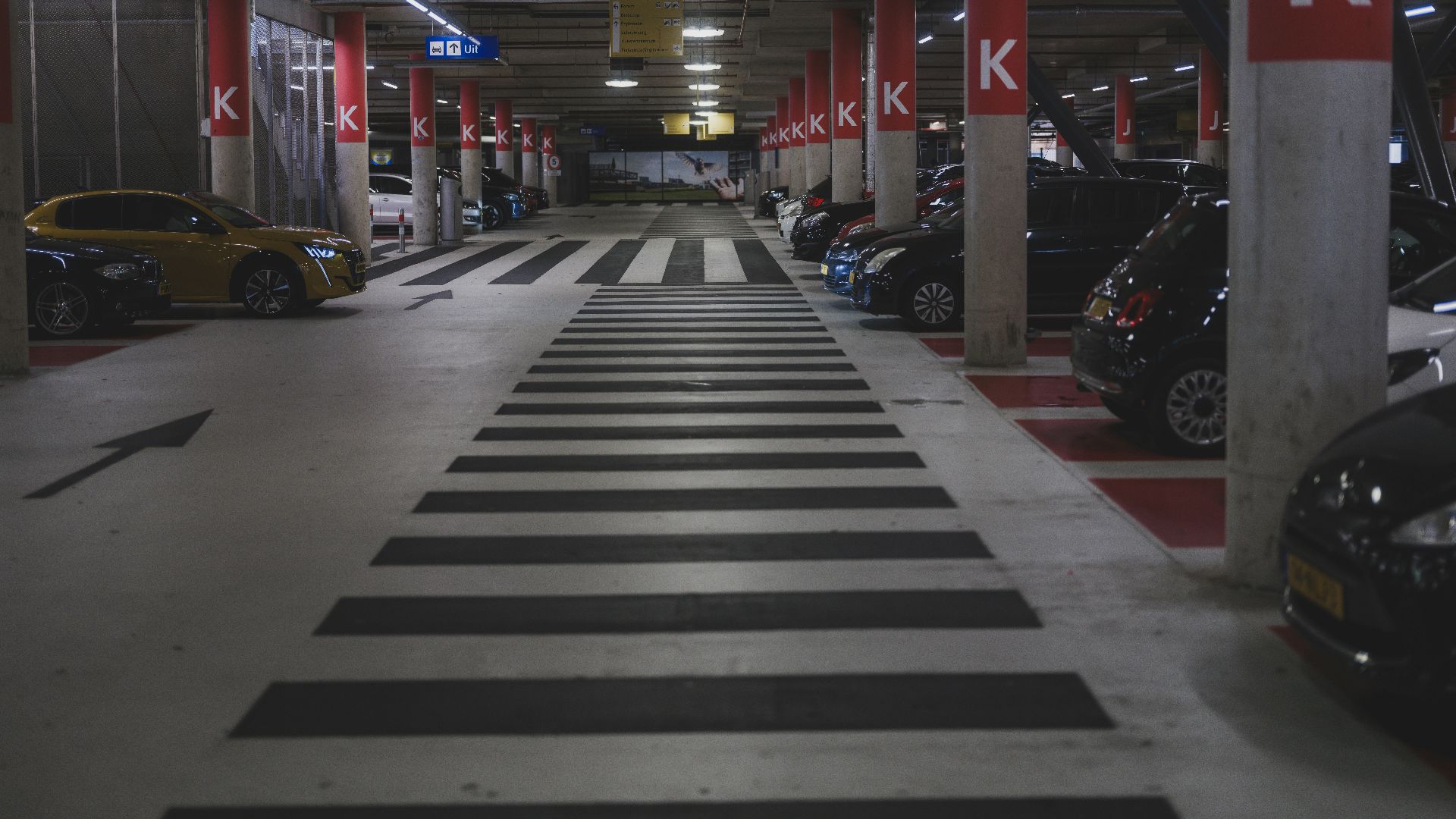 Cars parked in a dimly lit underground parking garage