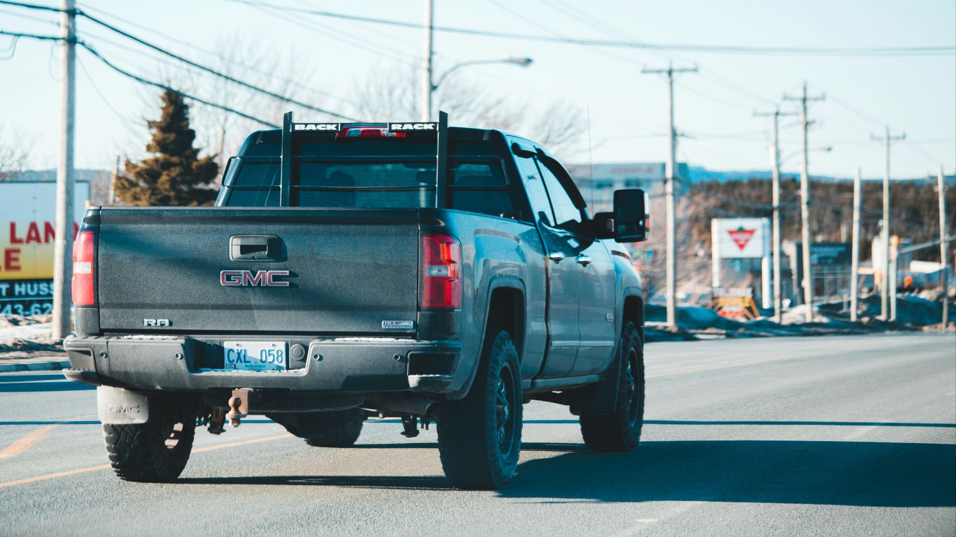 blue chevrolet crew cab pickup truck on road during daytime