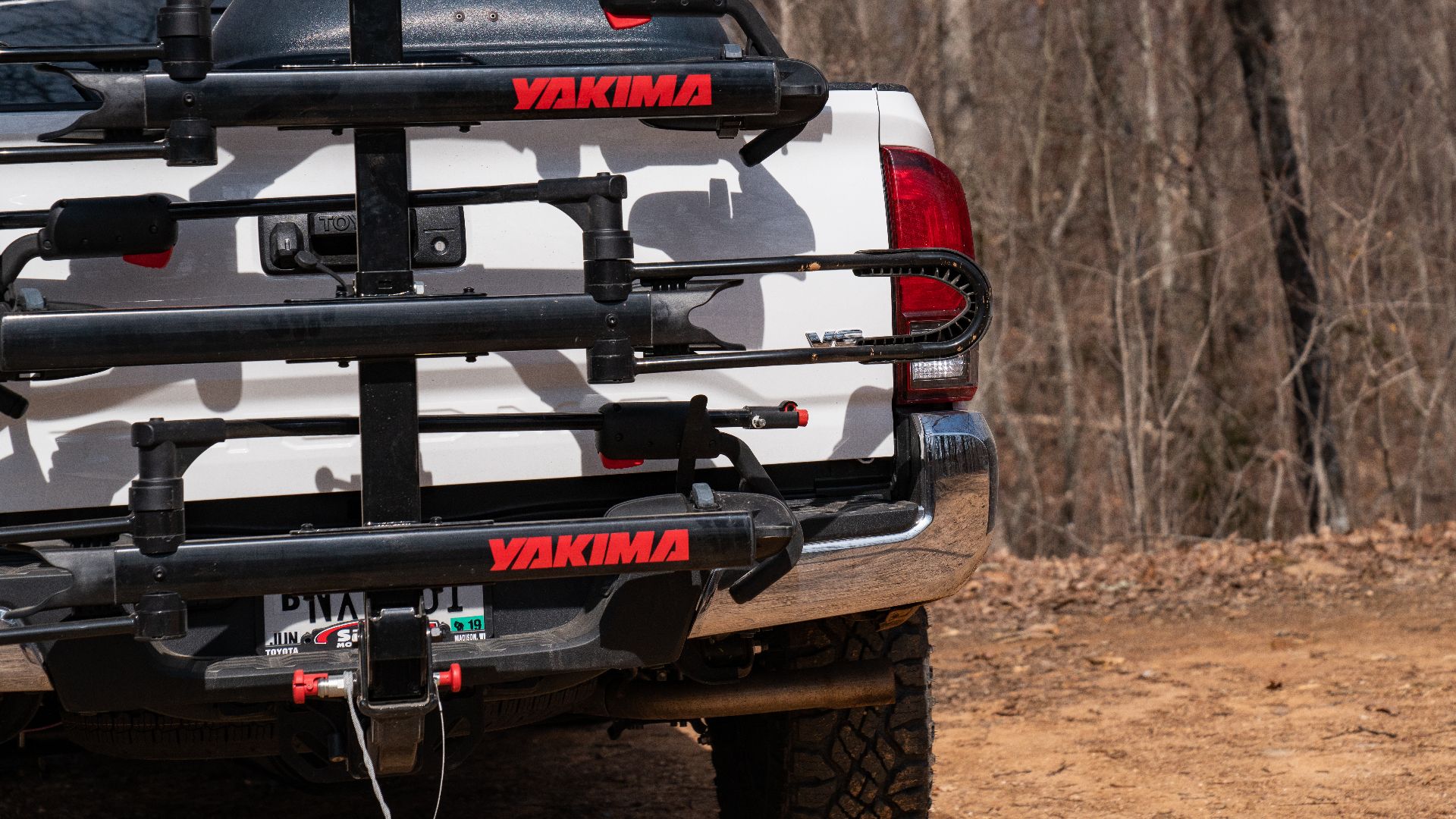 A hitch-mounted Yakima bike rack on the back of a pickup truck.