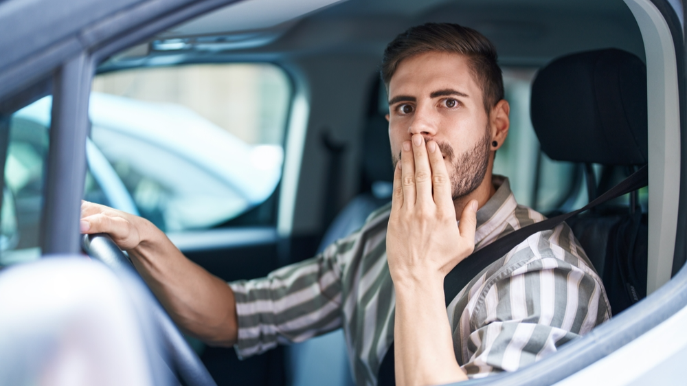 Shocked man in car looking at something