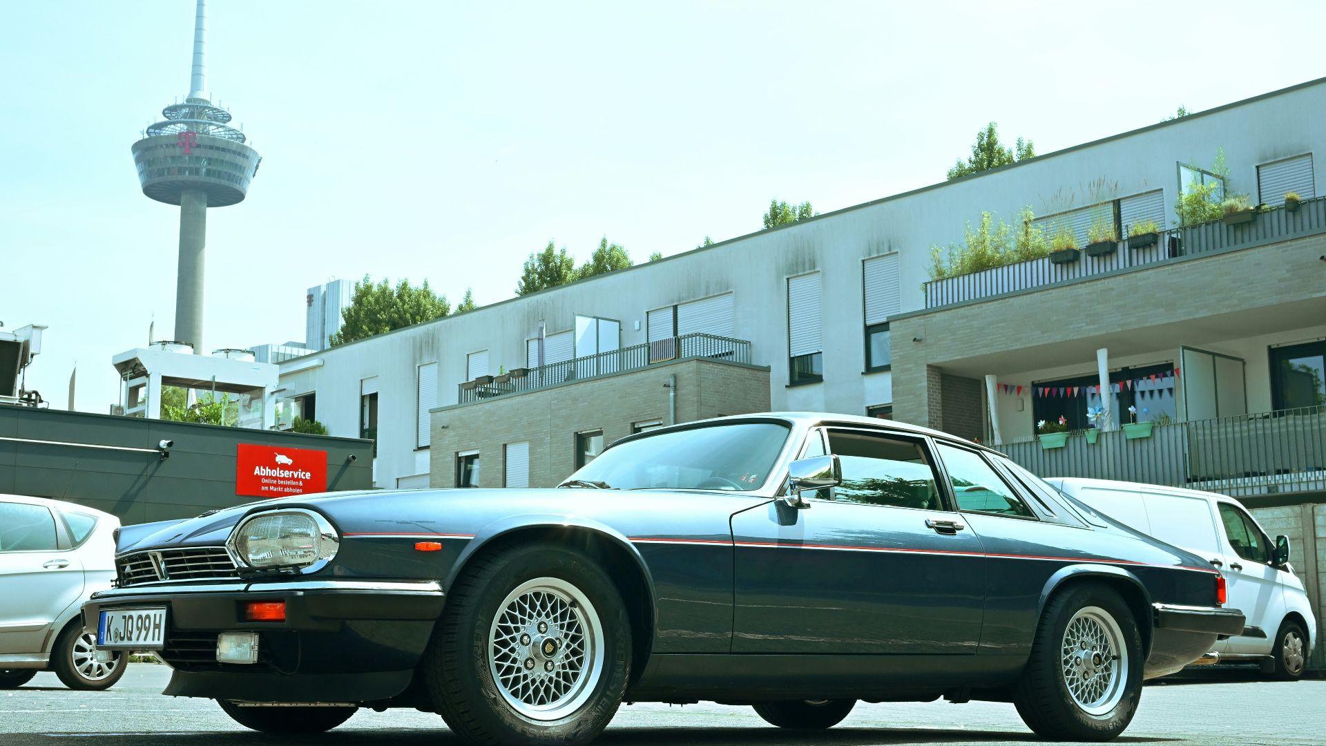 Classic dark blue jaguar xjs parked outdoors