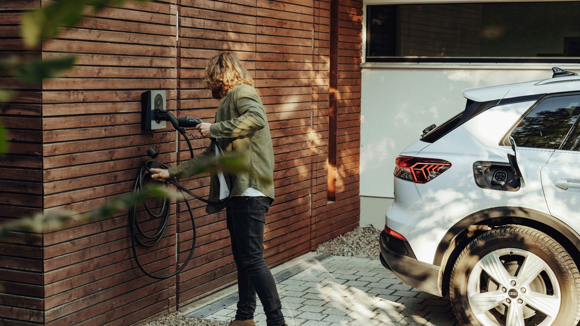 a woman is using a power washer on a brick wall