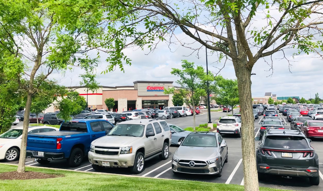 Dayton, Ohio, USA - June 11, 2023: Parking lot full of cars near Costco Wholesale warehouse store on a busy shopping day.