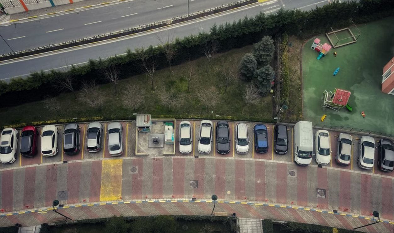Drone shot of cars parked along a curved road in Istanbul, Turkey