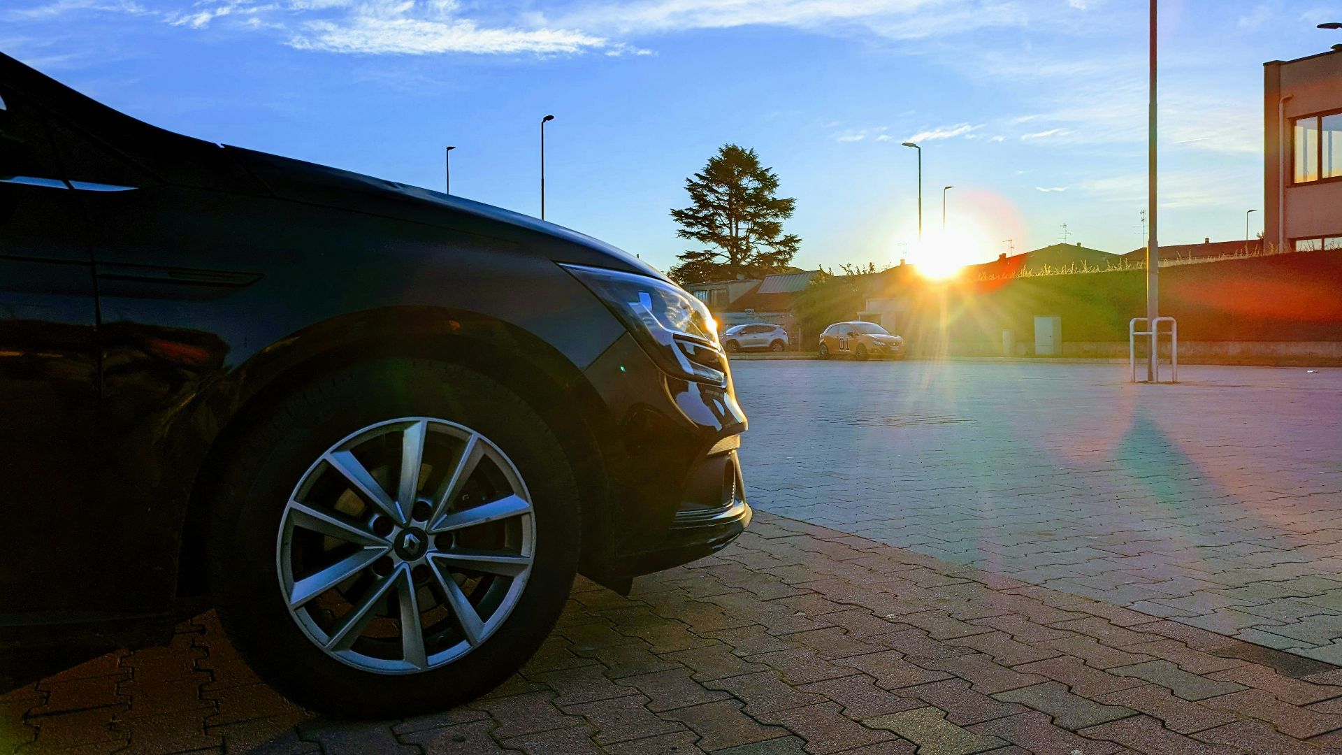a car parked in a parking lot at sunset