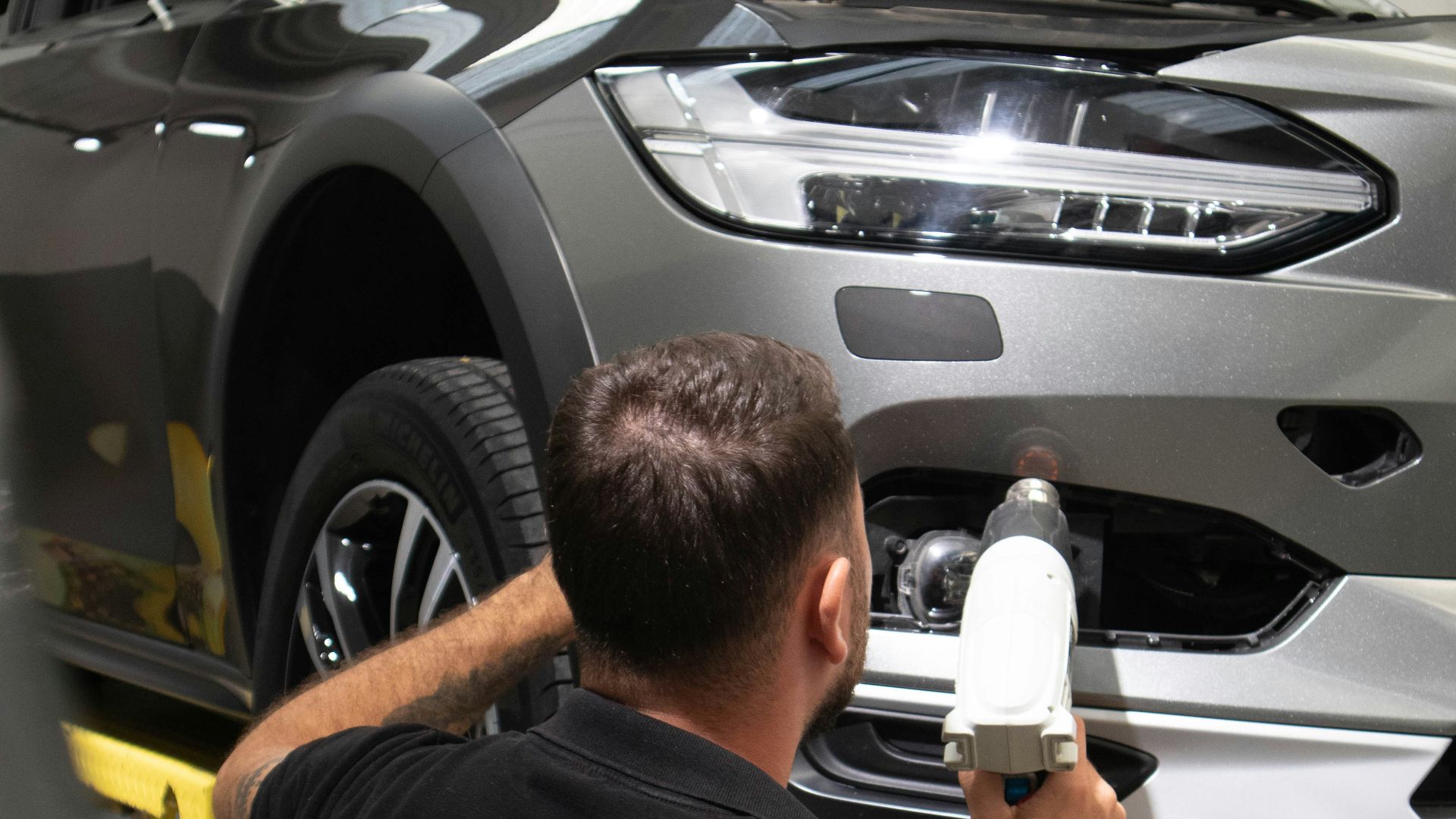 a man working on a car in a garage