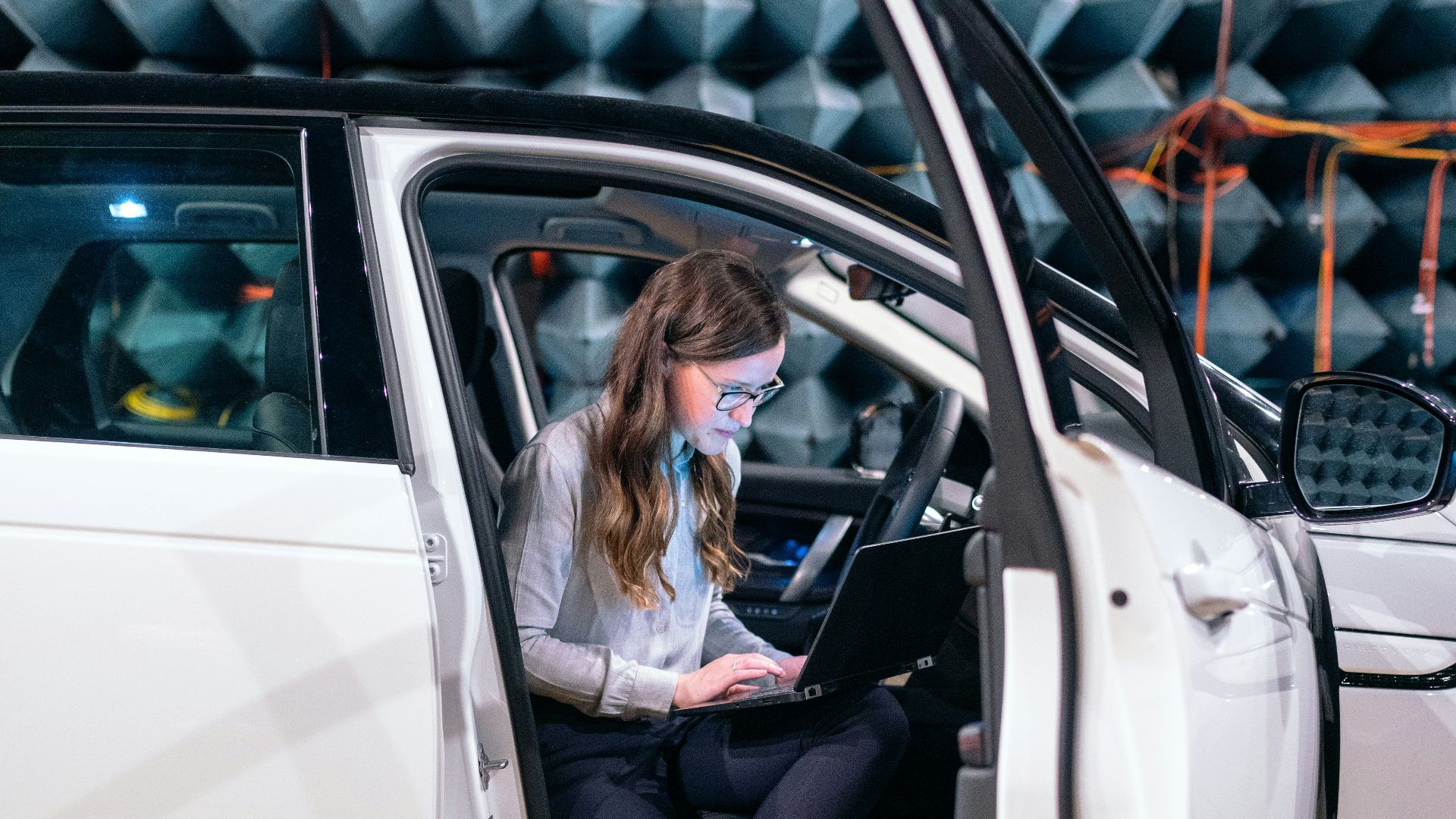 woman in white long sleeve shirt sitting on white car