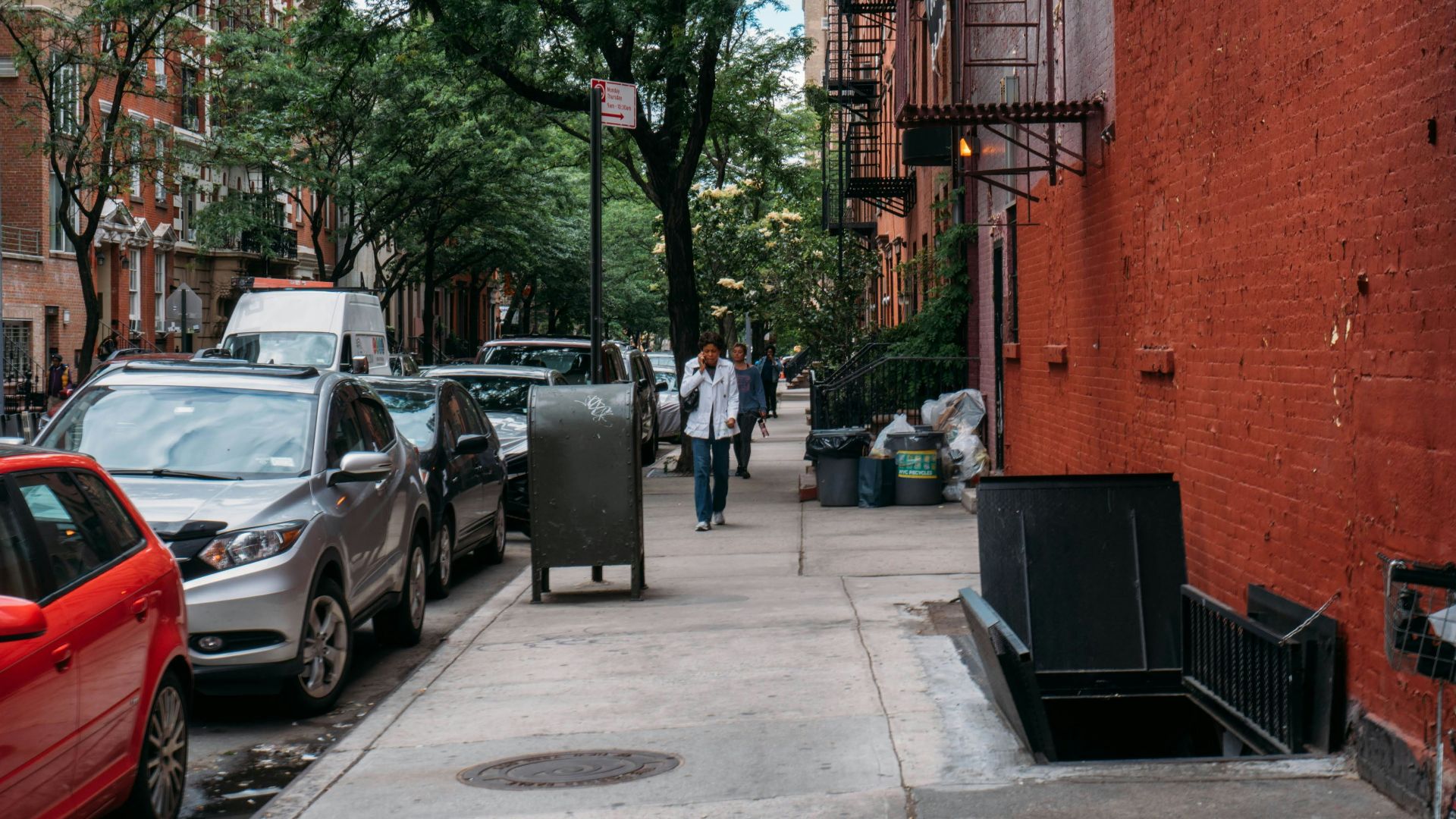 cars parked beside brown brick building during daytime