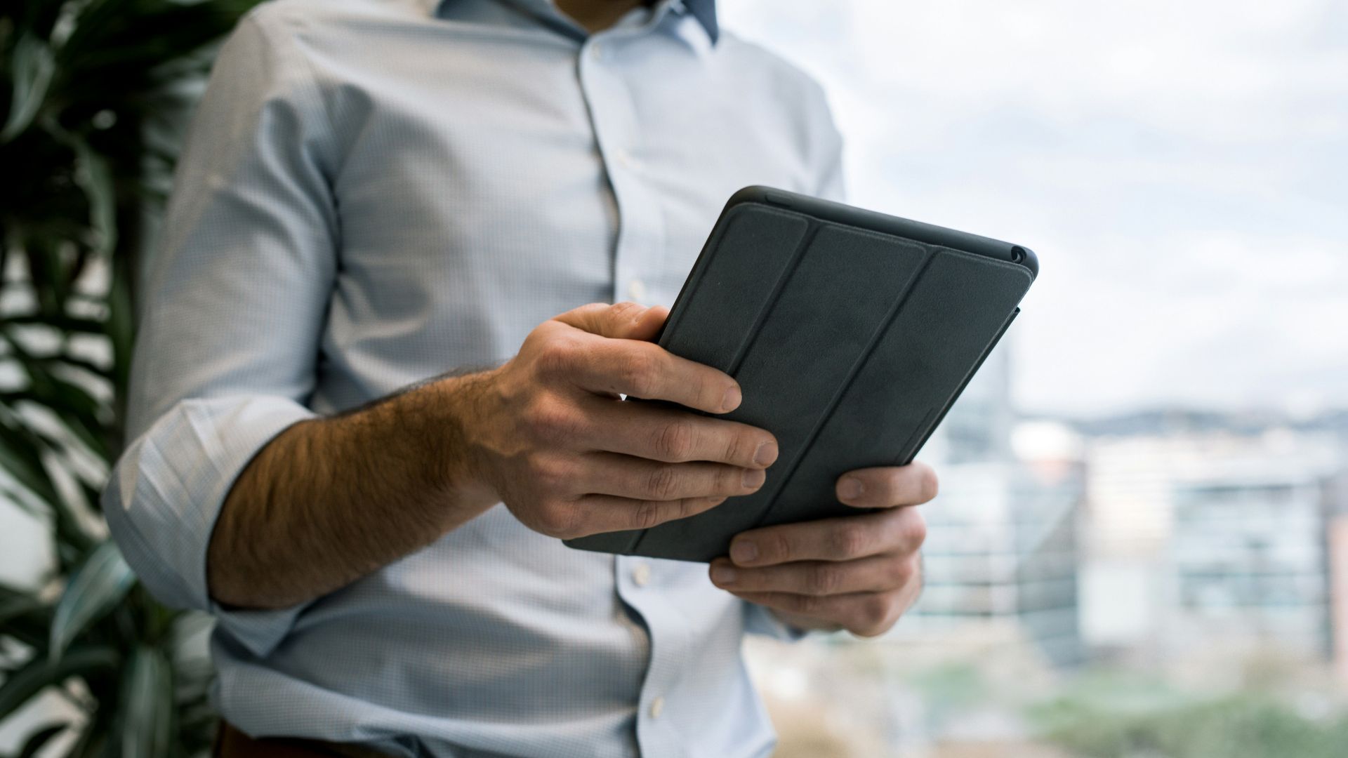 person holding black smart cover during daytime
