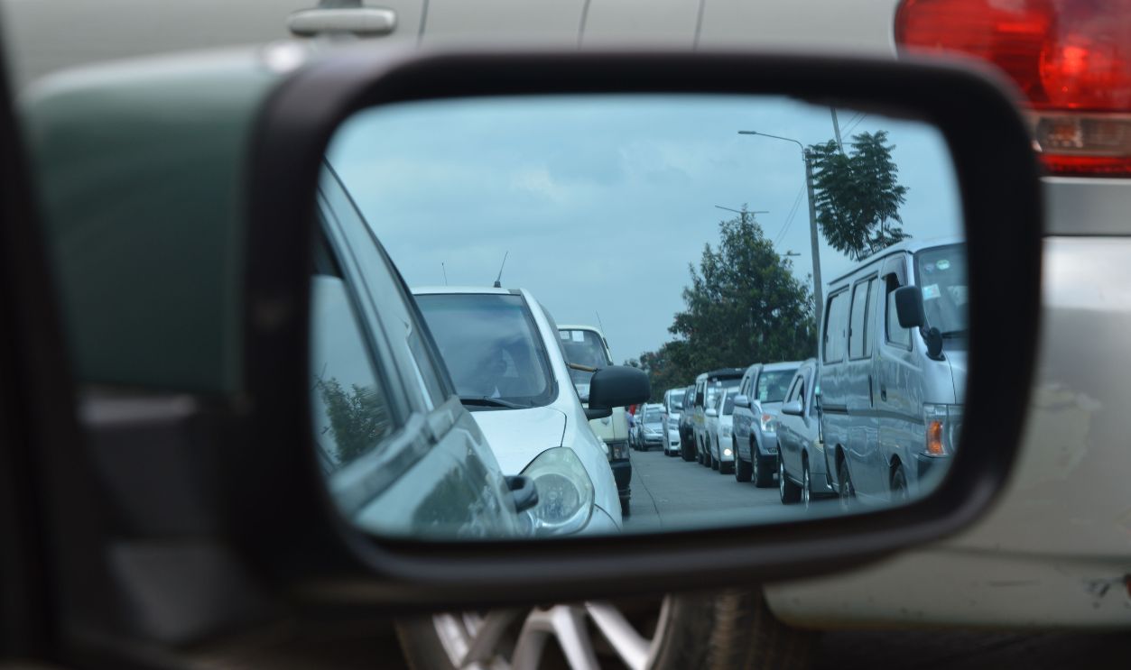 Reflection of a busy traffic jam in Nairobi captured through a car's side mirror.