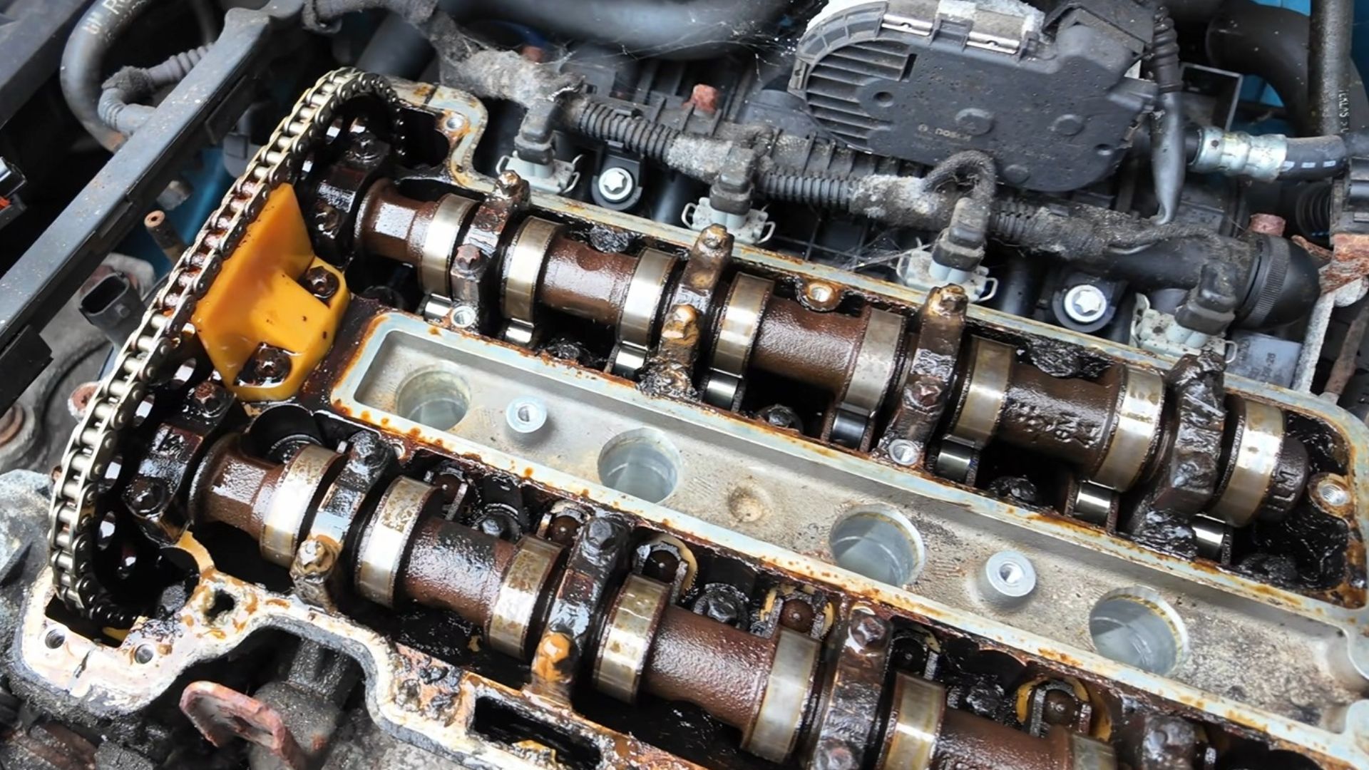 Oil sludge shown below the valve cover of a Vauxhall Corsa 1.2 Z12XE which had skipped some oil changes
