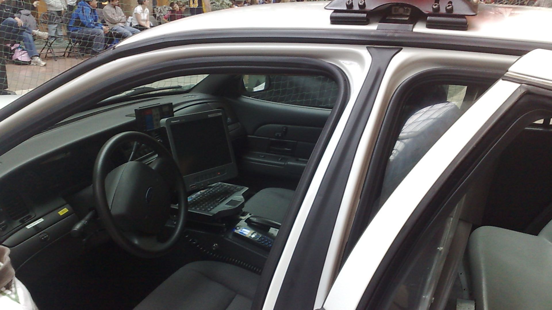 Cop car parked inside of Place Laurier, open for everyone to take a look at and explore.