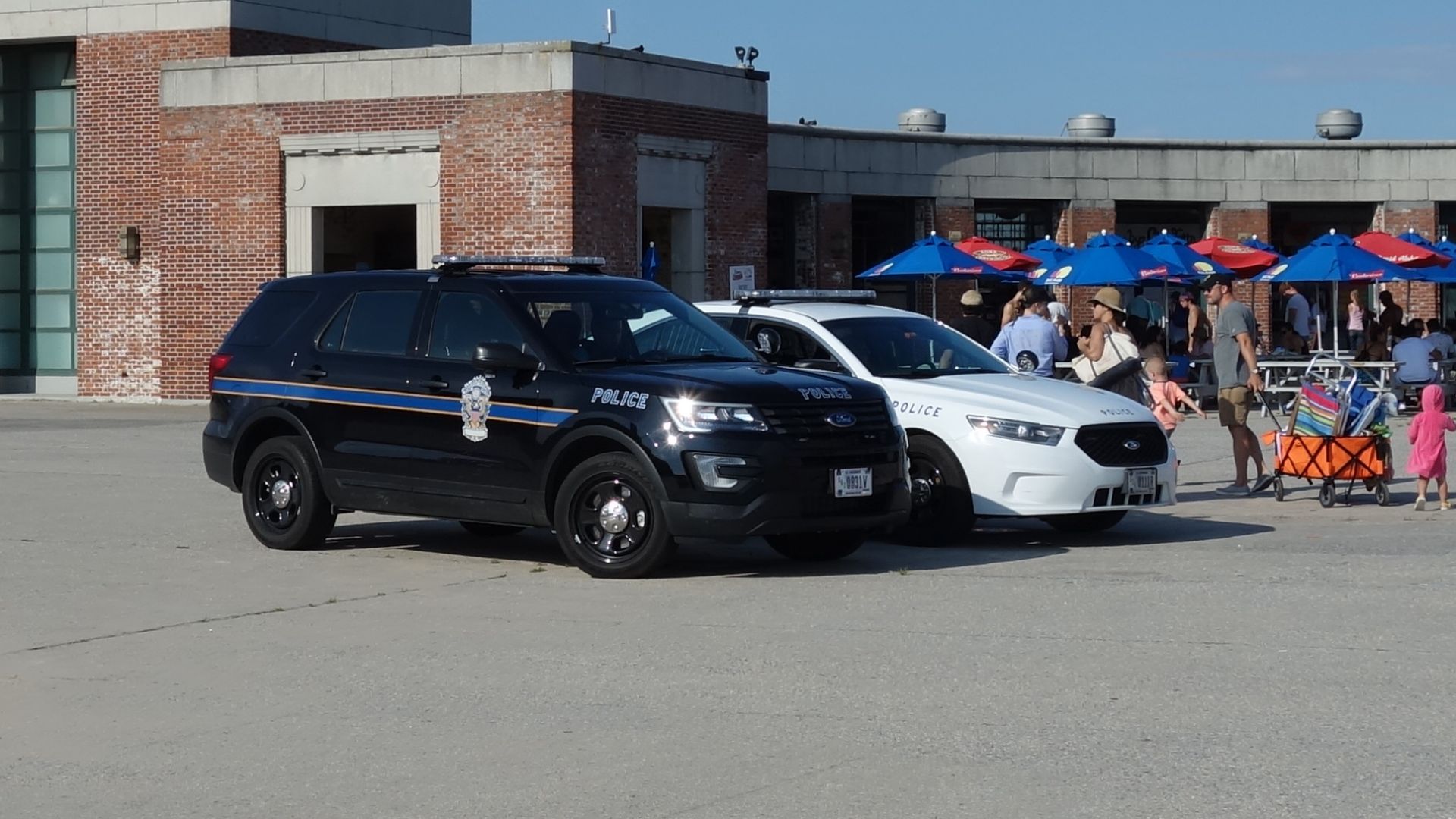 Two United States Park Police cars parked at the base of the central mall of Jacob Riis Park, east of Beach 169th Street in Rockaway, Queens.