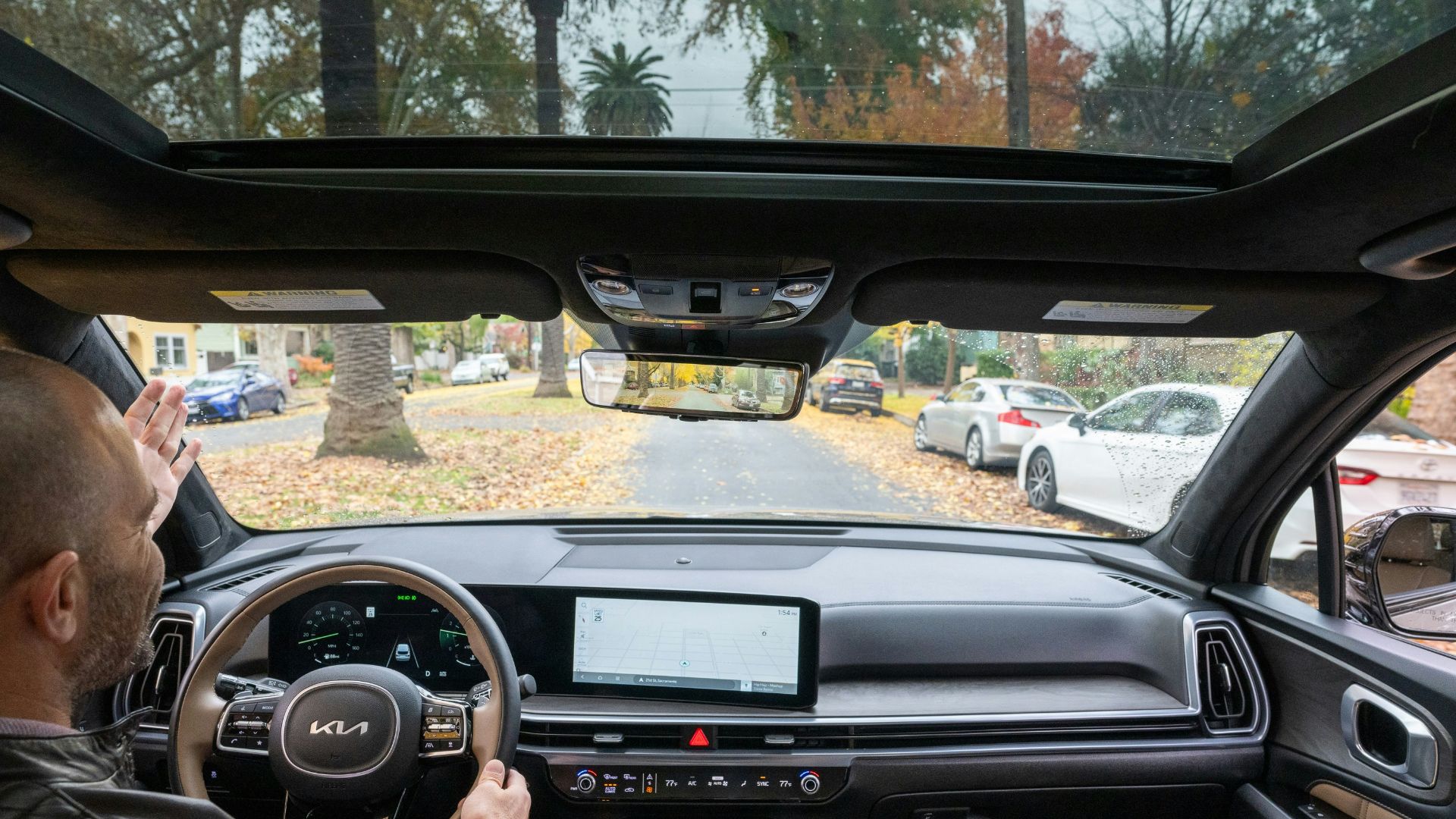 A man driving a car down a street