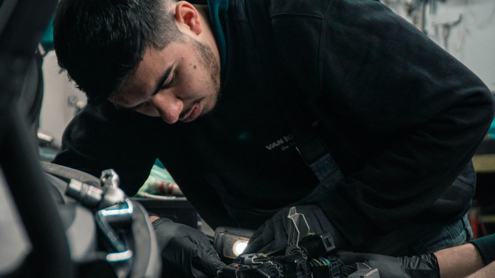 mechanic working on car engine