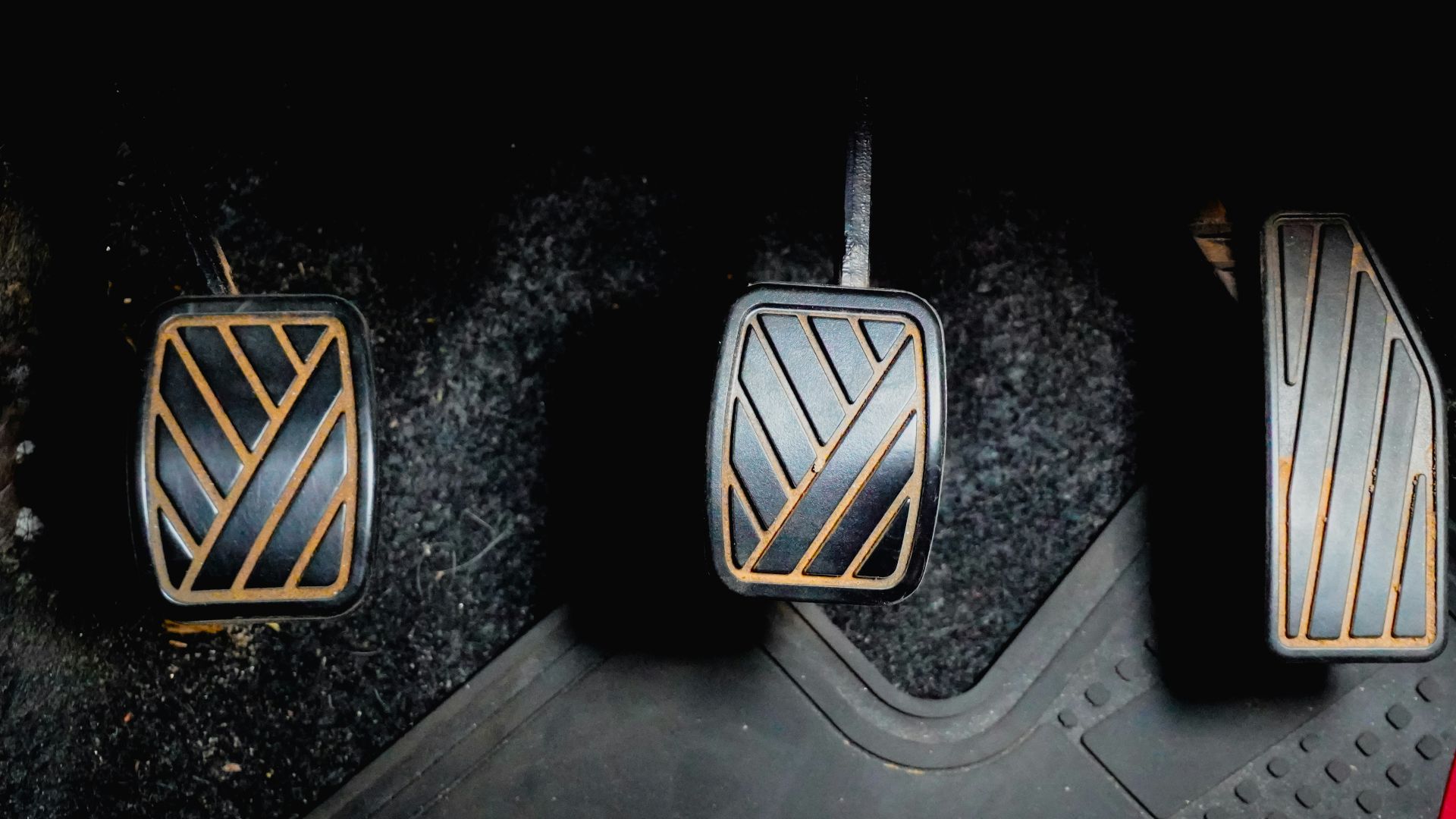 Three car pedals on the floor