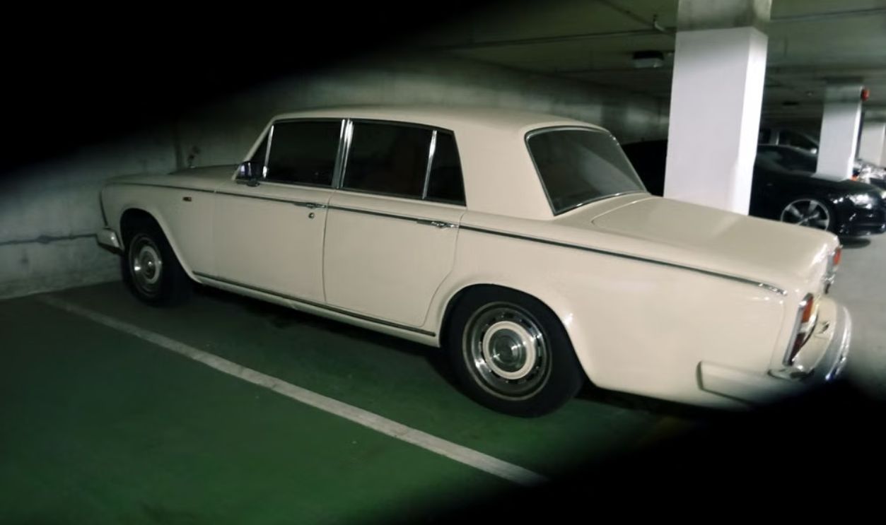 A classic vintage car parked in an underground parking lot, showcasing its retro design and elegance.