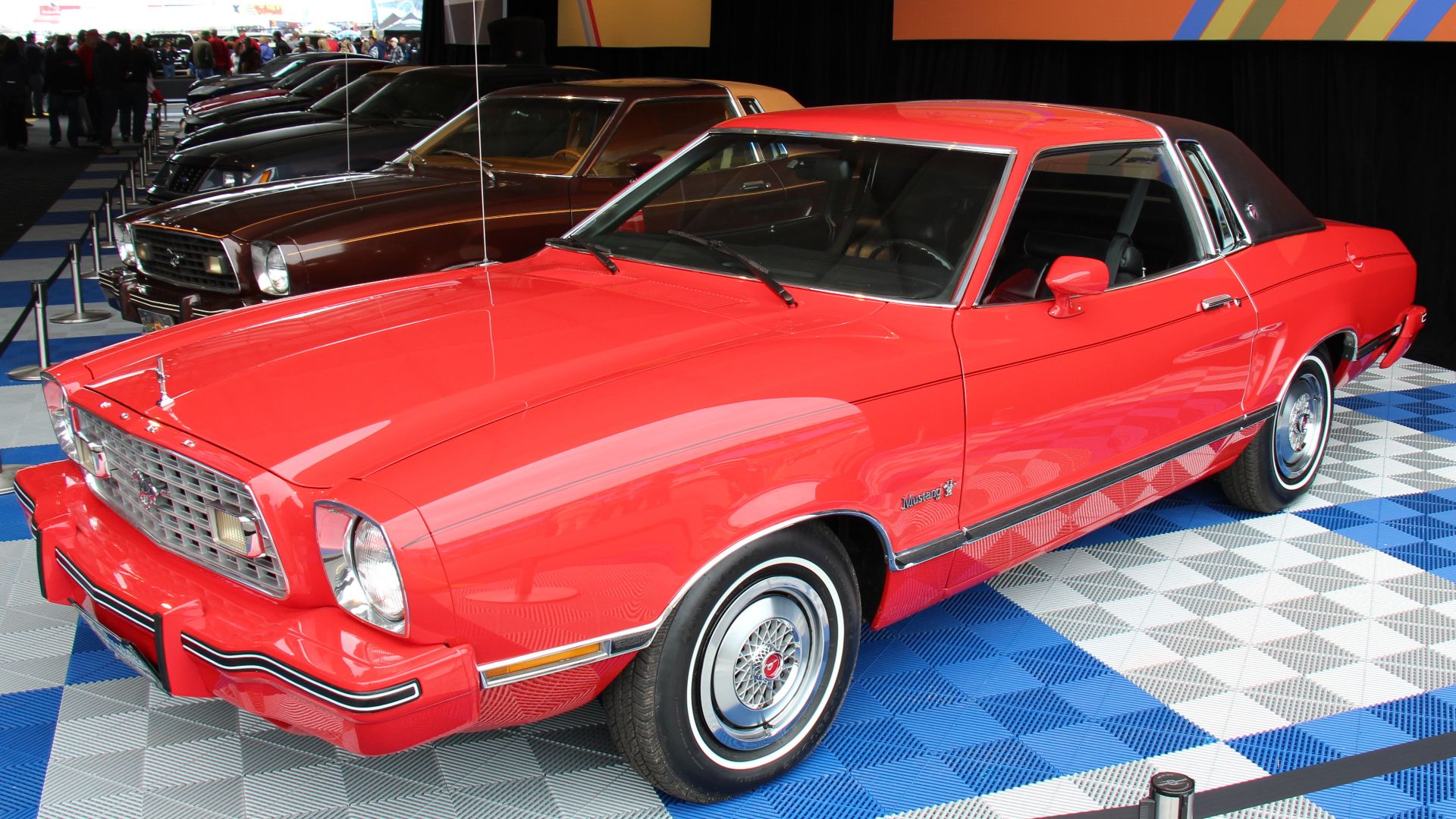Bright Red. 
The 1974-78 2nd generation Mustang followed world trends influenced by the oil crisis etc and was a smaller car again. In 1974, only available with a 140 cu in 4 cyl or 171 cu in V6. The engine bay was modified and the V8 brought back in 1975