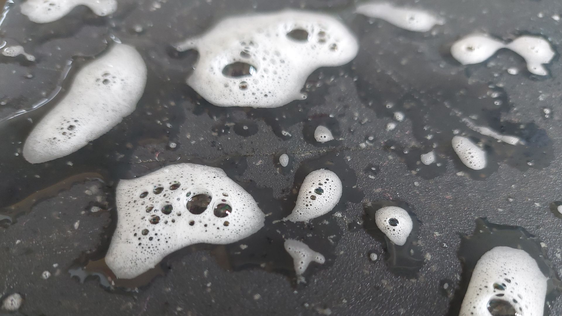 Soap foam on black surface